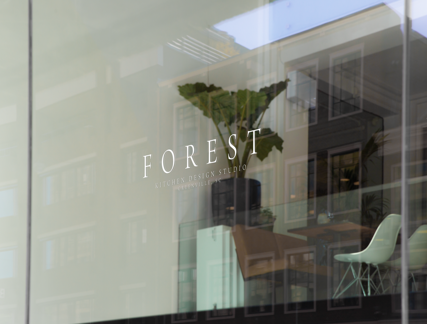 Modern storefront window with elegant 'FOREST' text etched in minimalist typography.