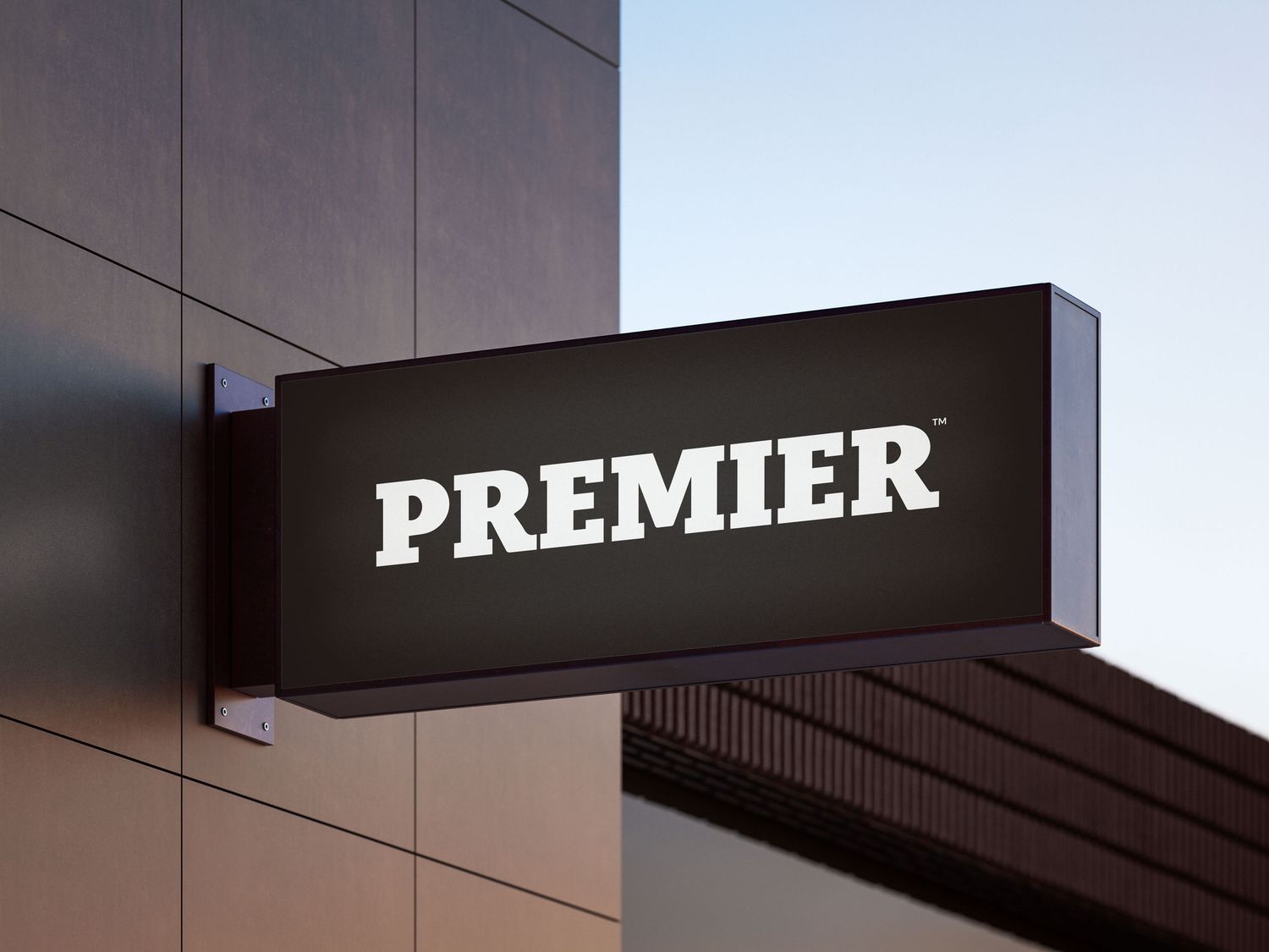 A black illuminated wall-mounted sign reading PREMIER in bold white serif font on a modern building exterior.