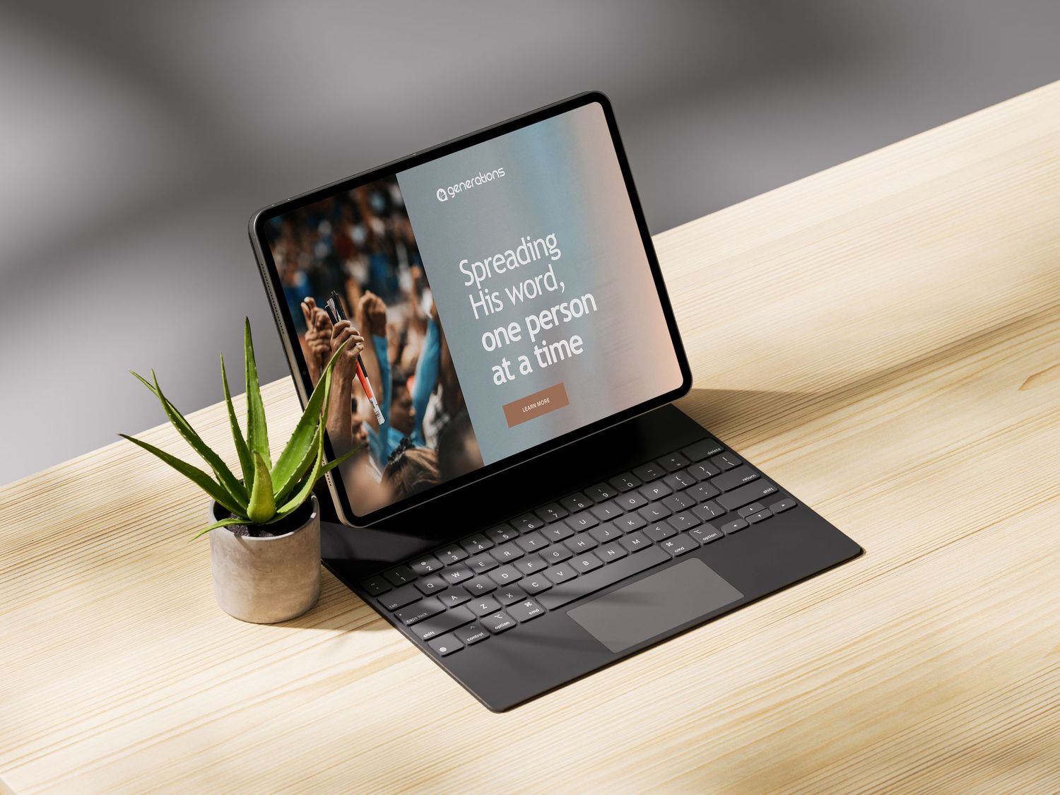 Modern laptop with text display sitting on wooden desk with small potted plant.