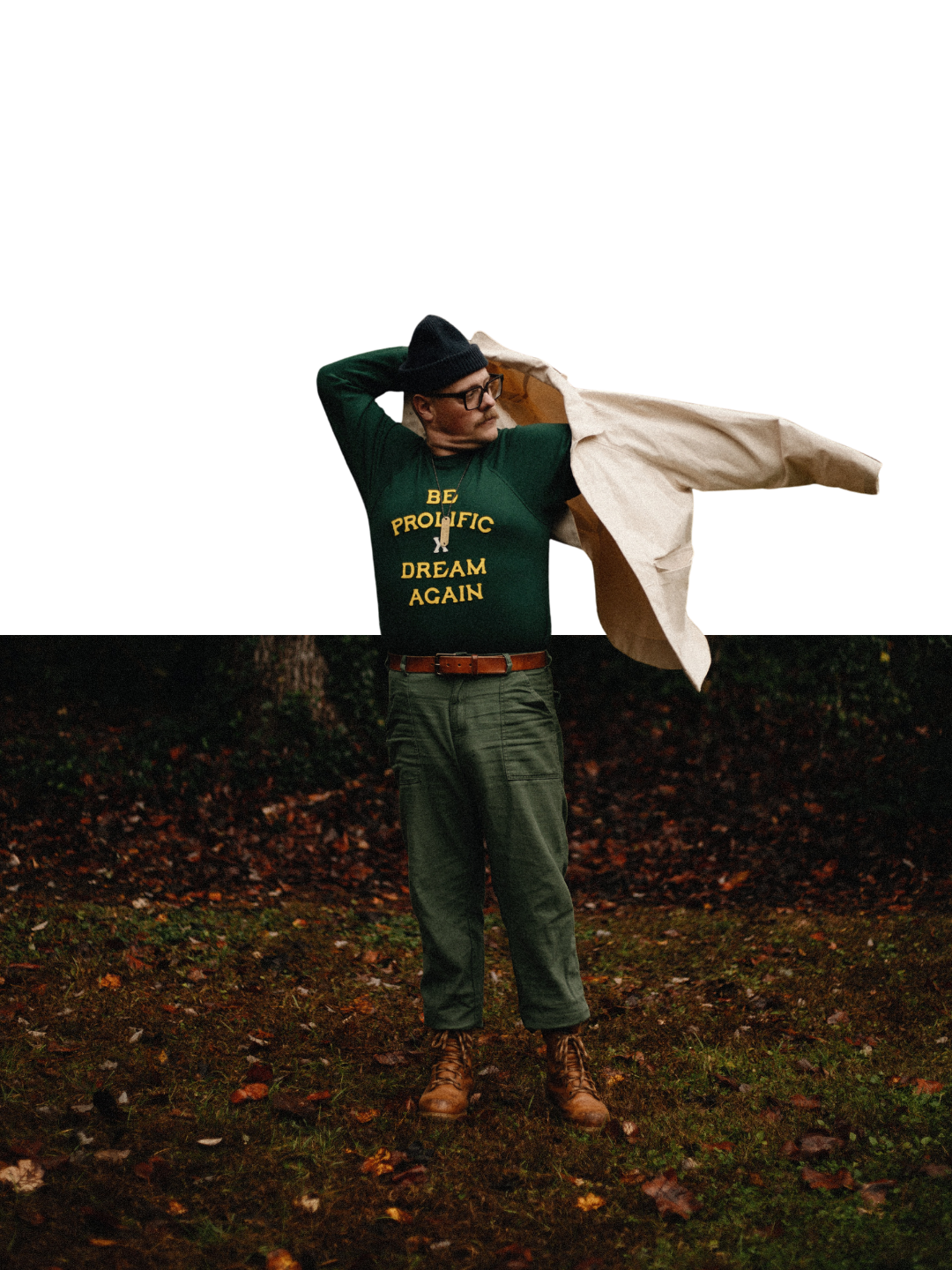 Man in a beanie, glasses and green 