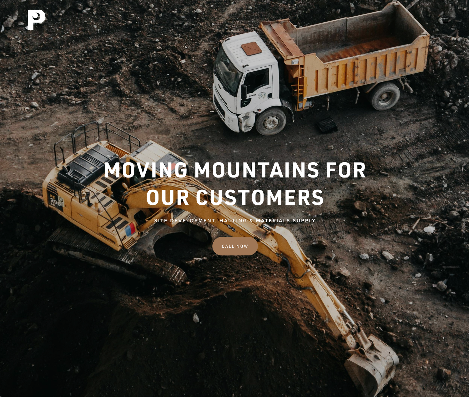 Aerial view of construction equipment and dump trucks working at industrial site.