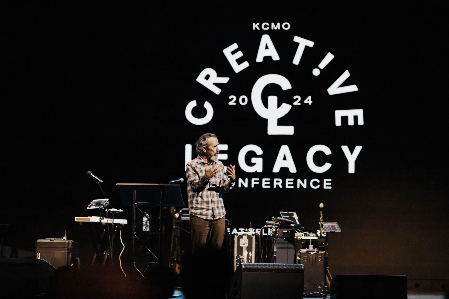 Creative Legacy 2024 Conference keynote speaker on stage in Kansas City with live band setup