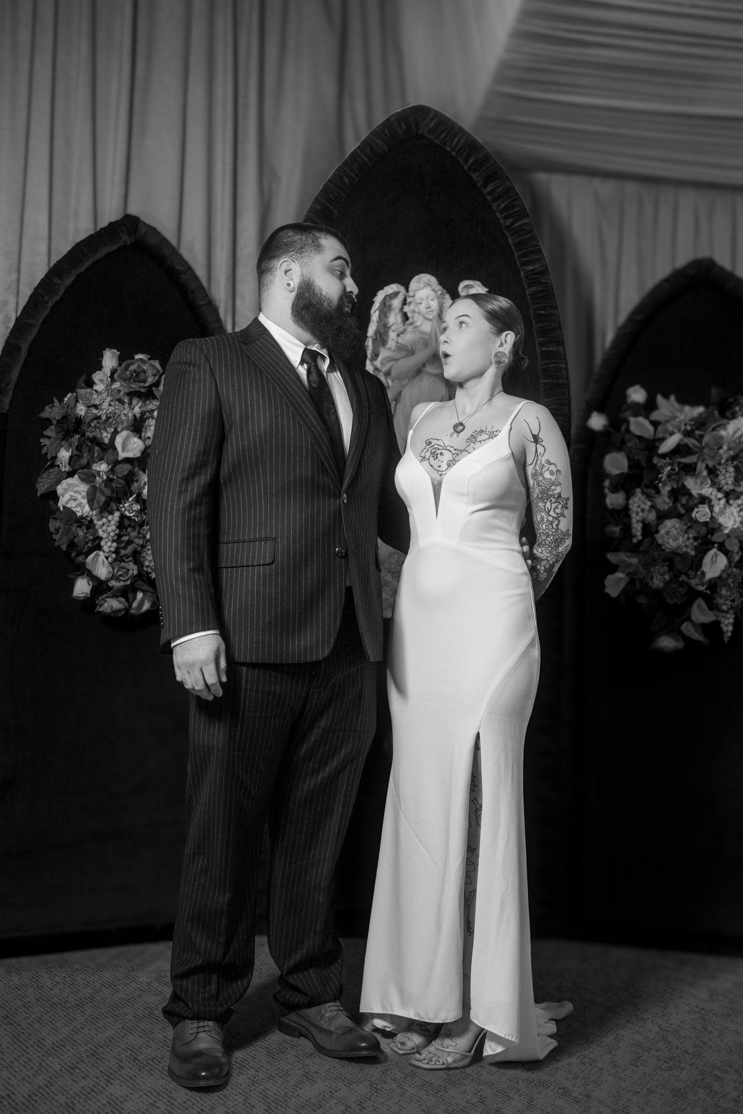 A black and white photo series showing couples dancing and embracing at a formal event with floral decorations.