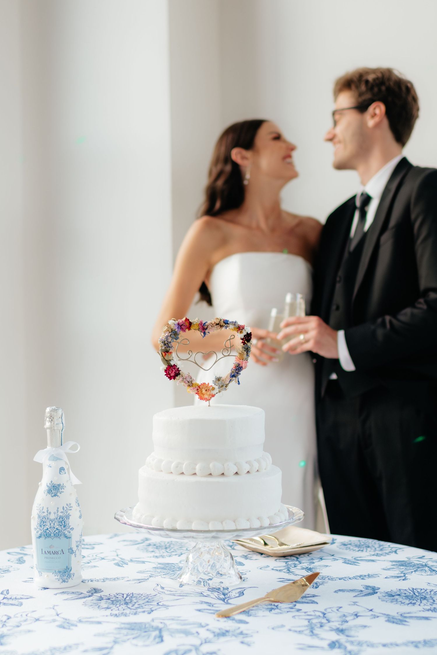 a couple clinks champagne glasses during their wedding cake cutting at their wedding reception in gadsden, alabama