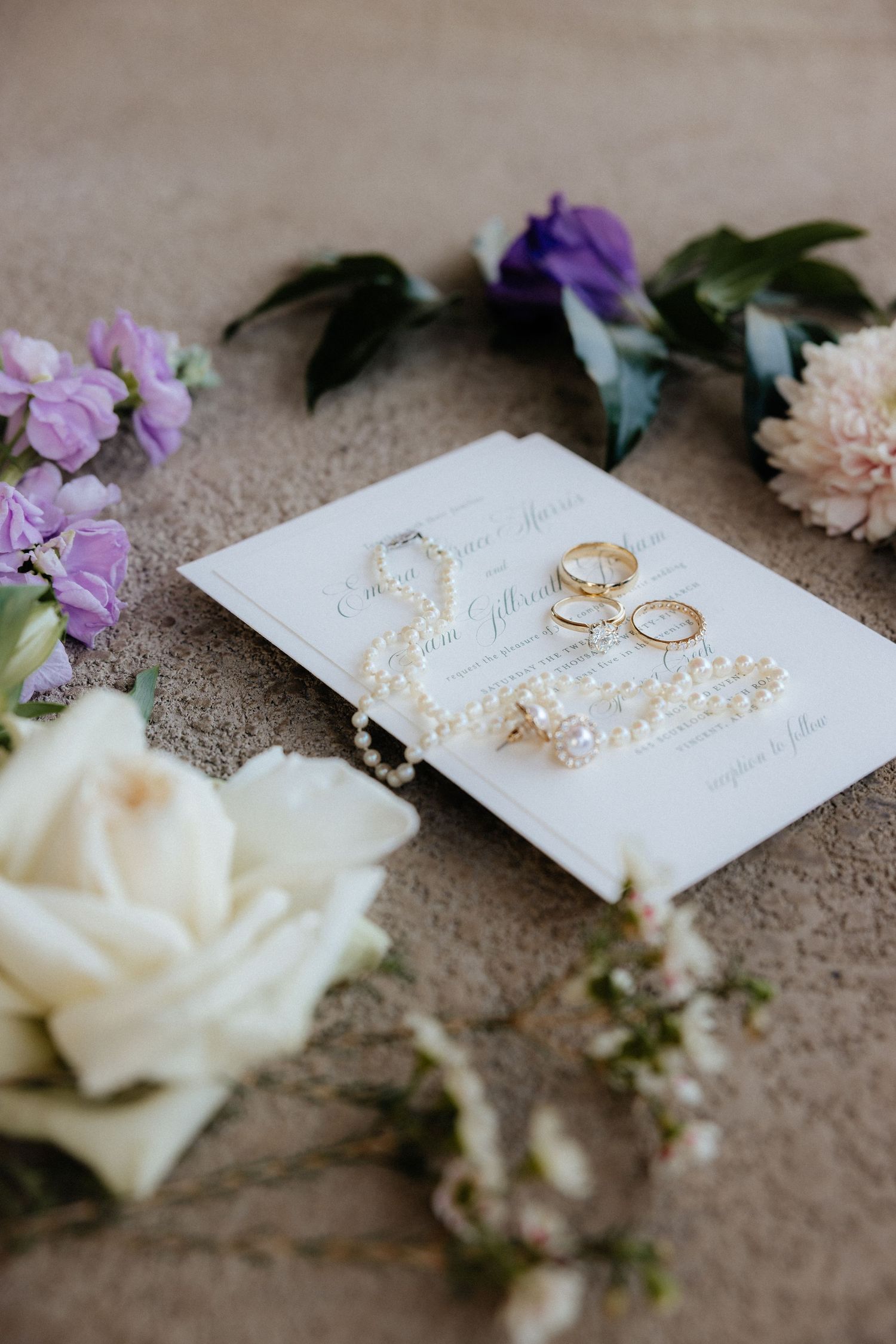 purple and white florals and wedding details from a flat lay from a spring wedding in Vincent, alabama photographed by Sarah Mismash photo