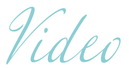 Elegant cursive script spelling Video in soft teal blue color on white background.