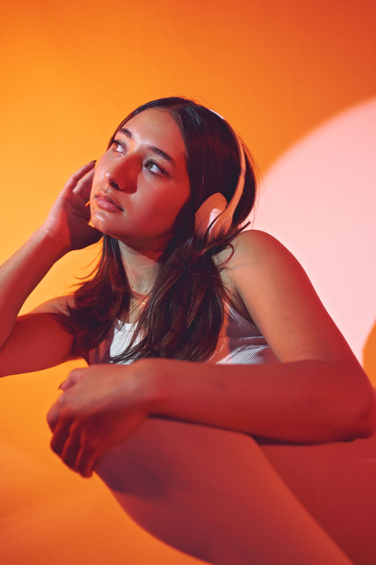 Editorial photography shot of a woman wearing headphones in a photography studio in Oakland CA.