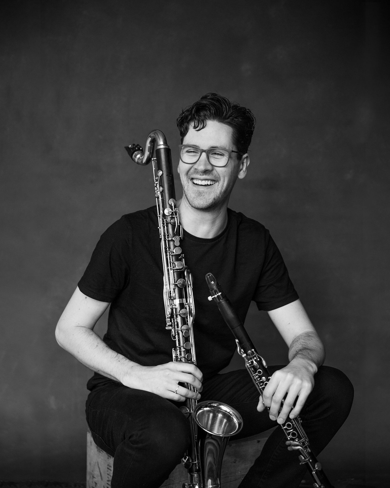 Man in blank posing with a musical instrument