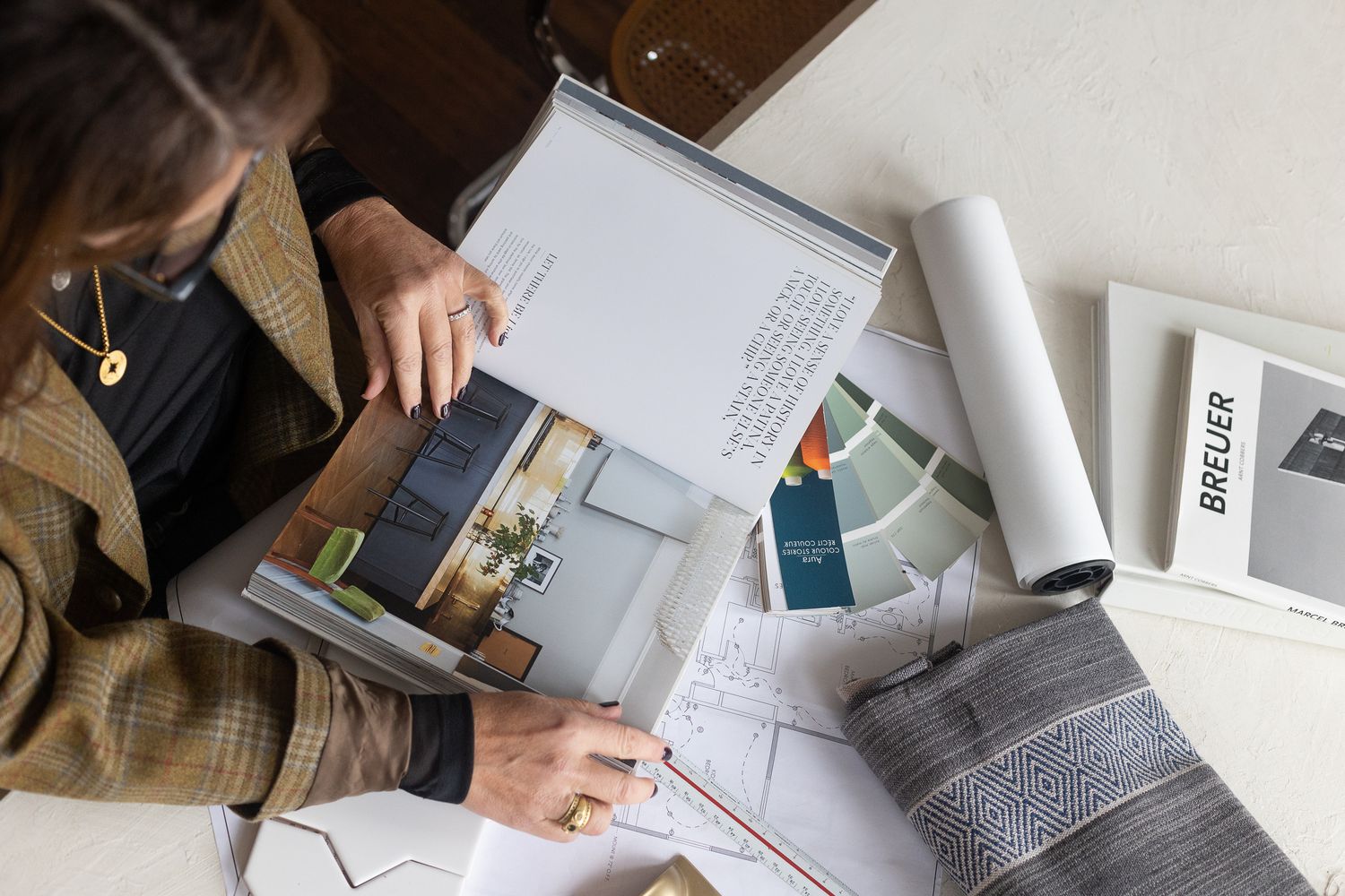 designer at a table reviewing her design plans