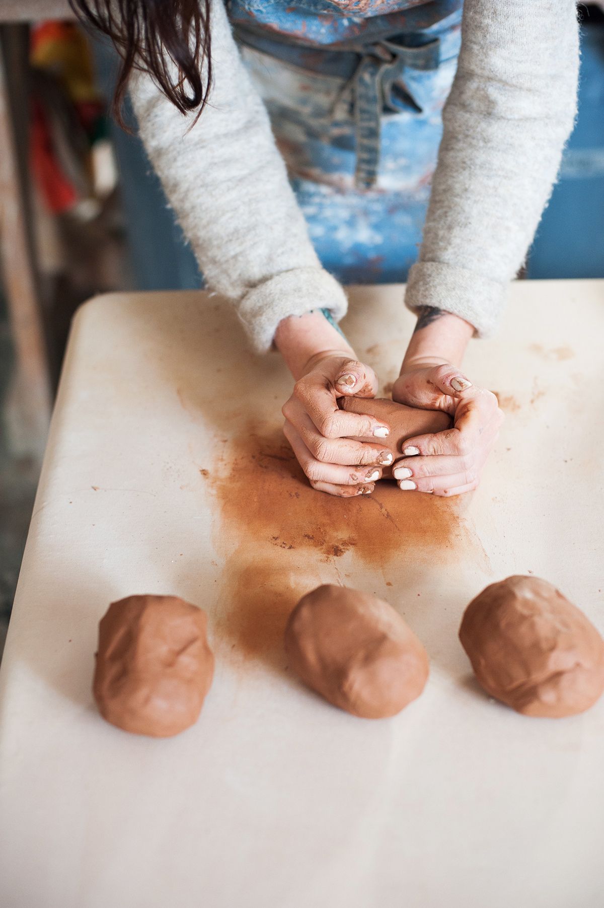 Woman preparing clay in a ceramics studio