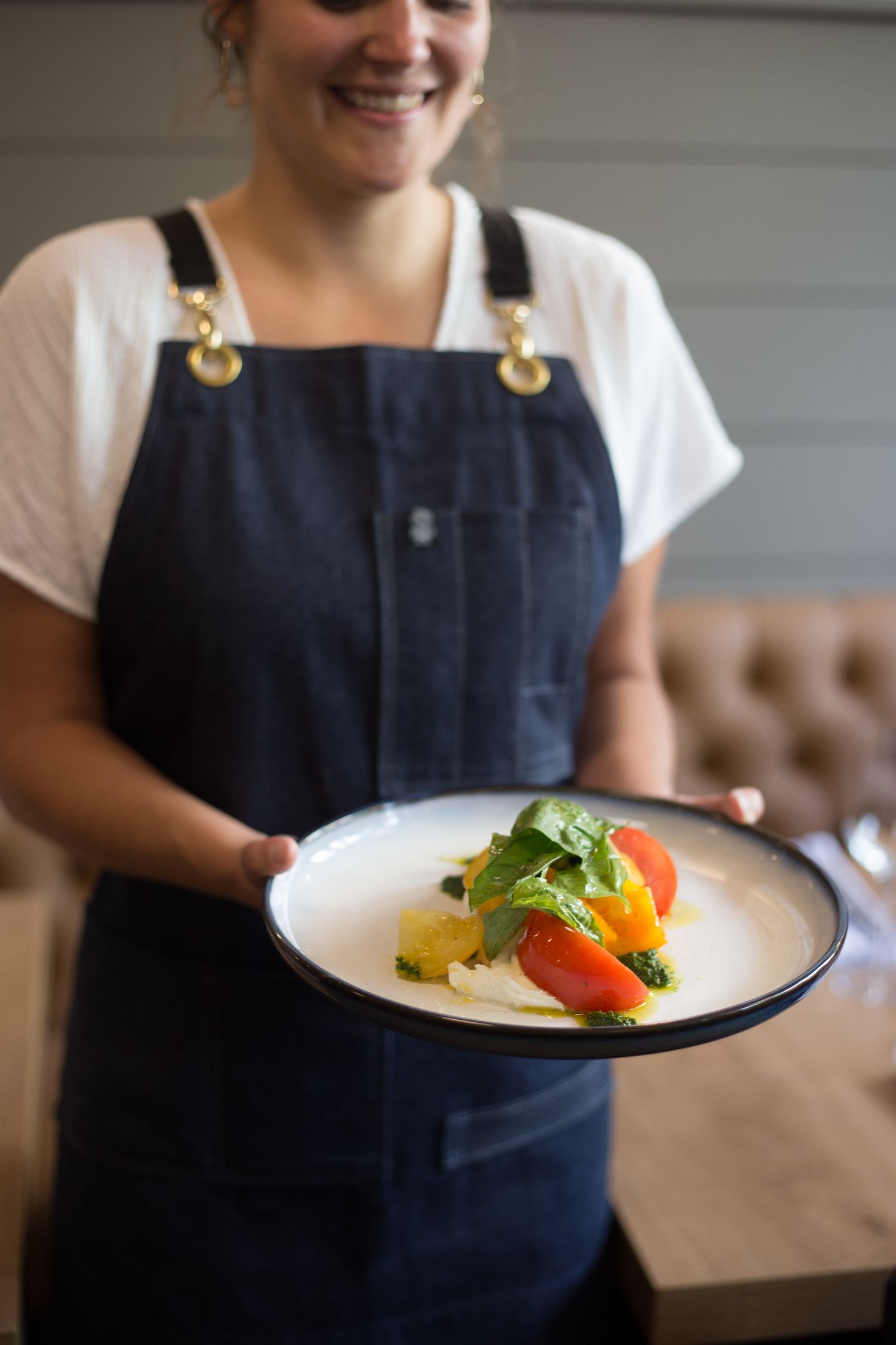 Restaurant Server holding a plate with a vibrant salad