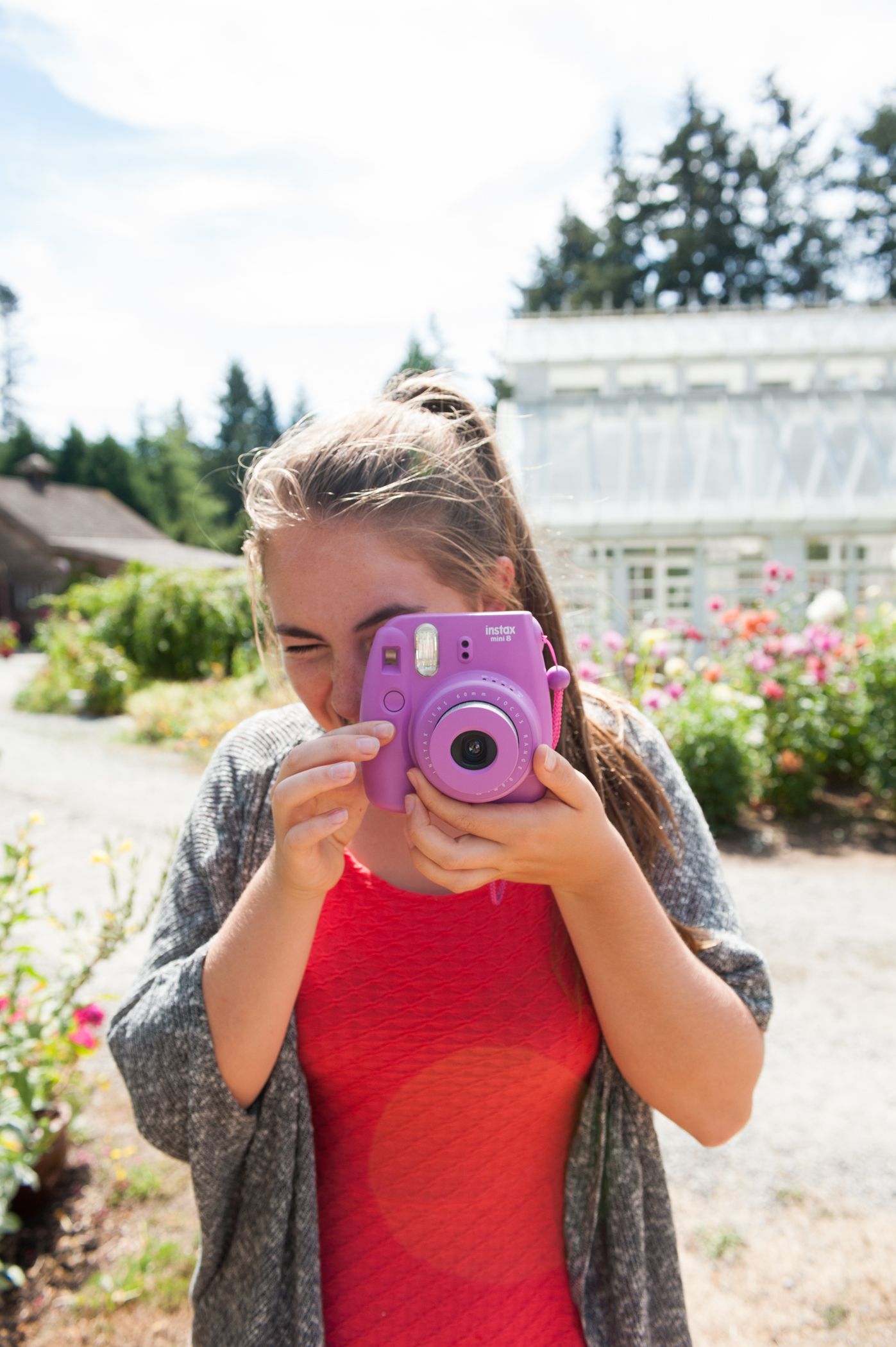 Young woman using a polaroid camera