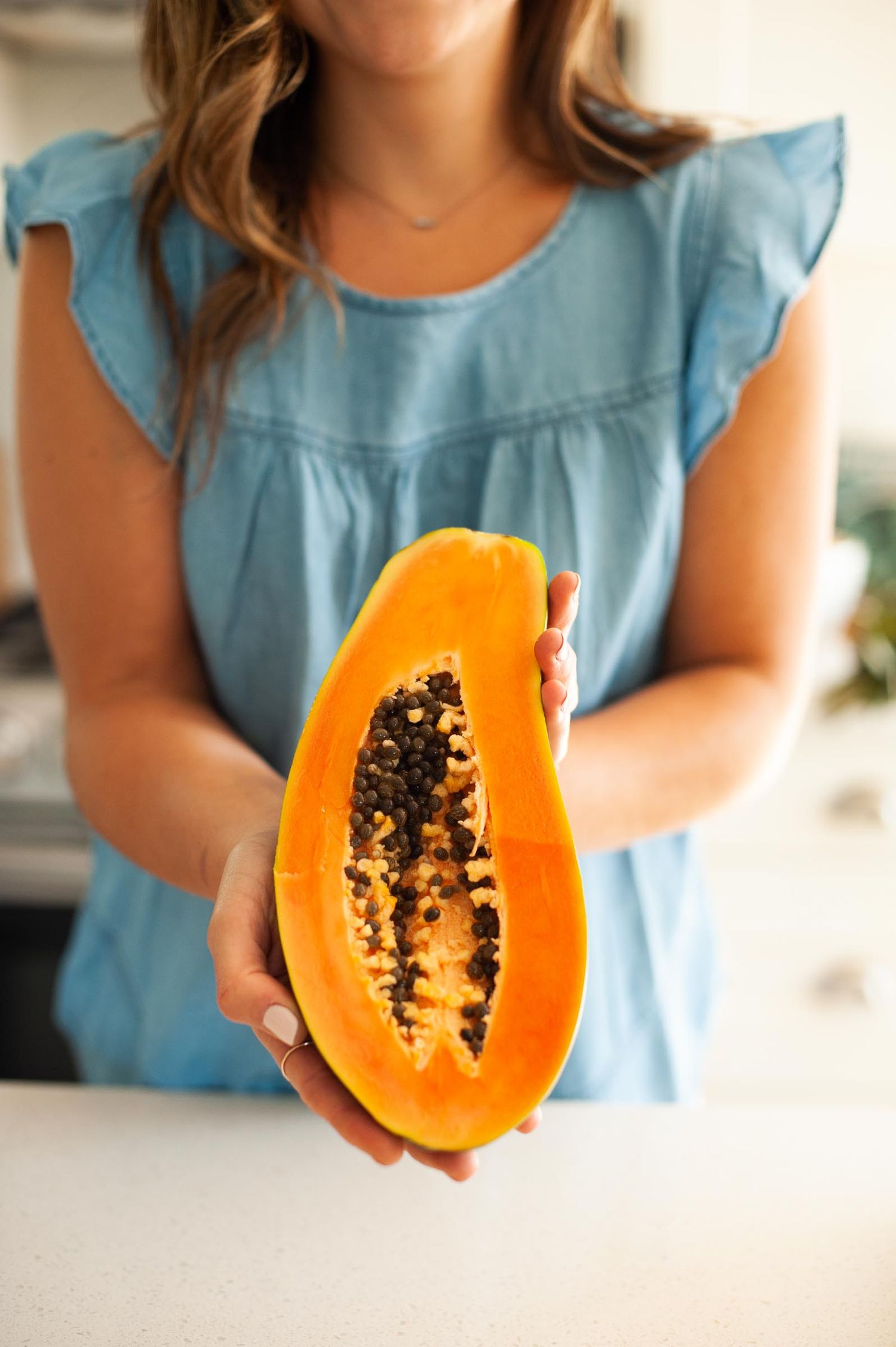 Woman holding a colourful fruit