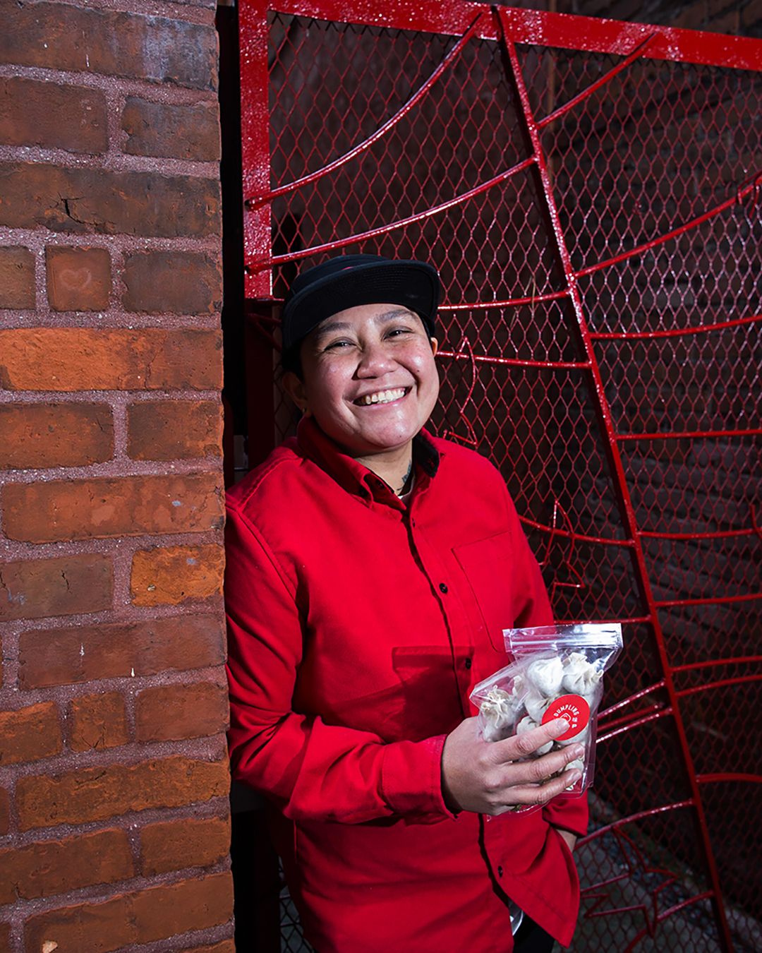 Young asian woman in a red shirt smiling