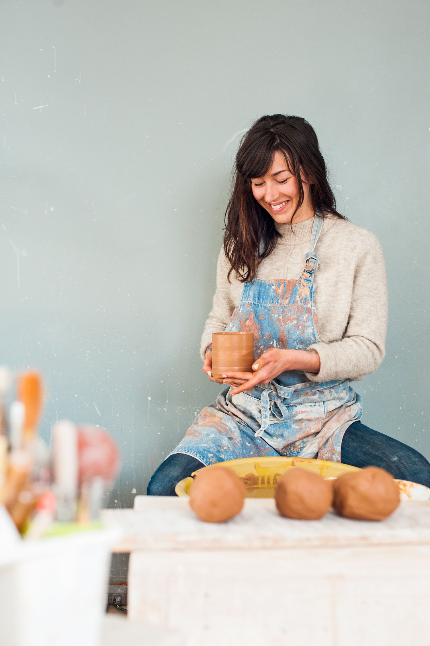 Woman sitting at a pottery wheel