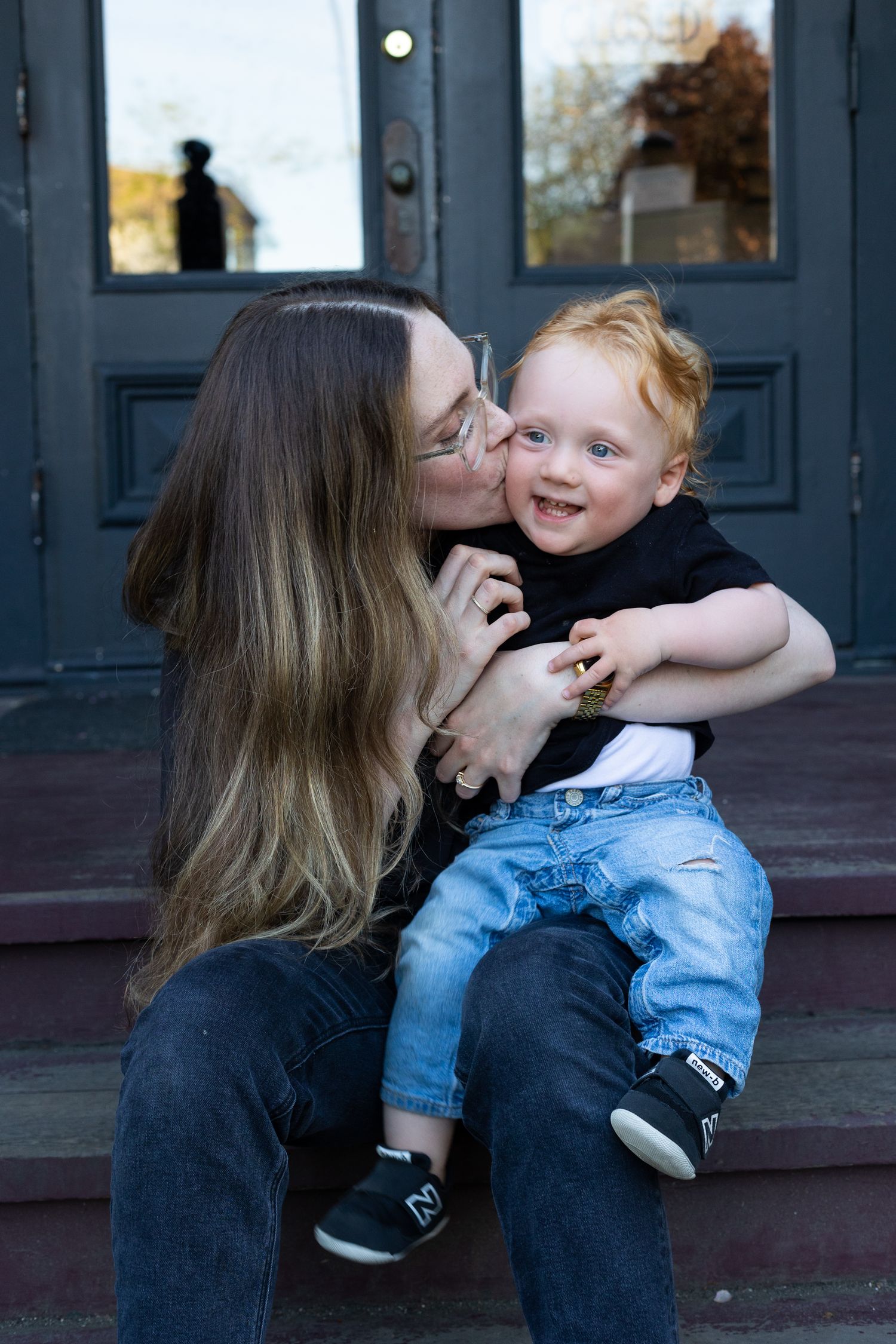 Mom snuggling with a laughing baby on her lap