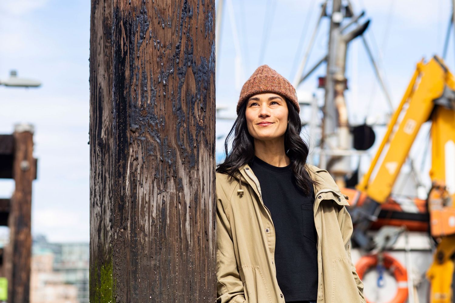 woman in a knitted hat looking up to the sky