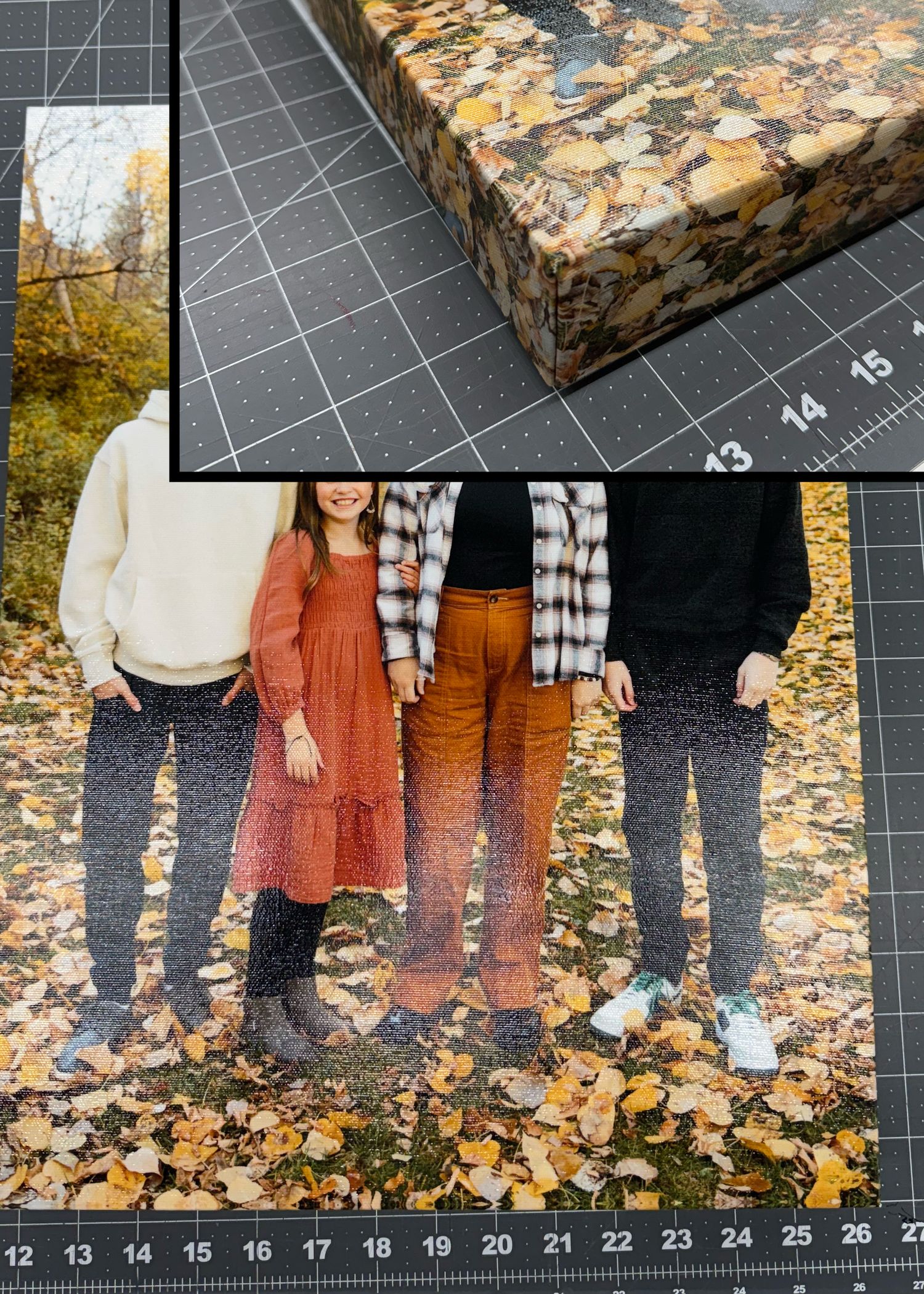 Family of three standing among autumn leaves, shown as a canvas print on a cutting mat with ruler.