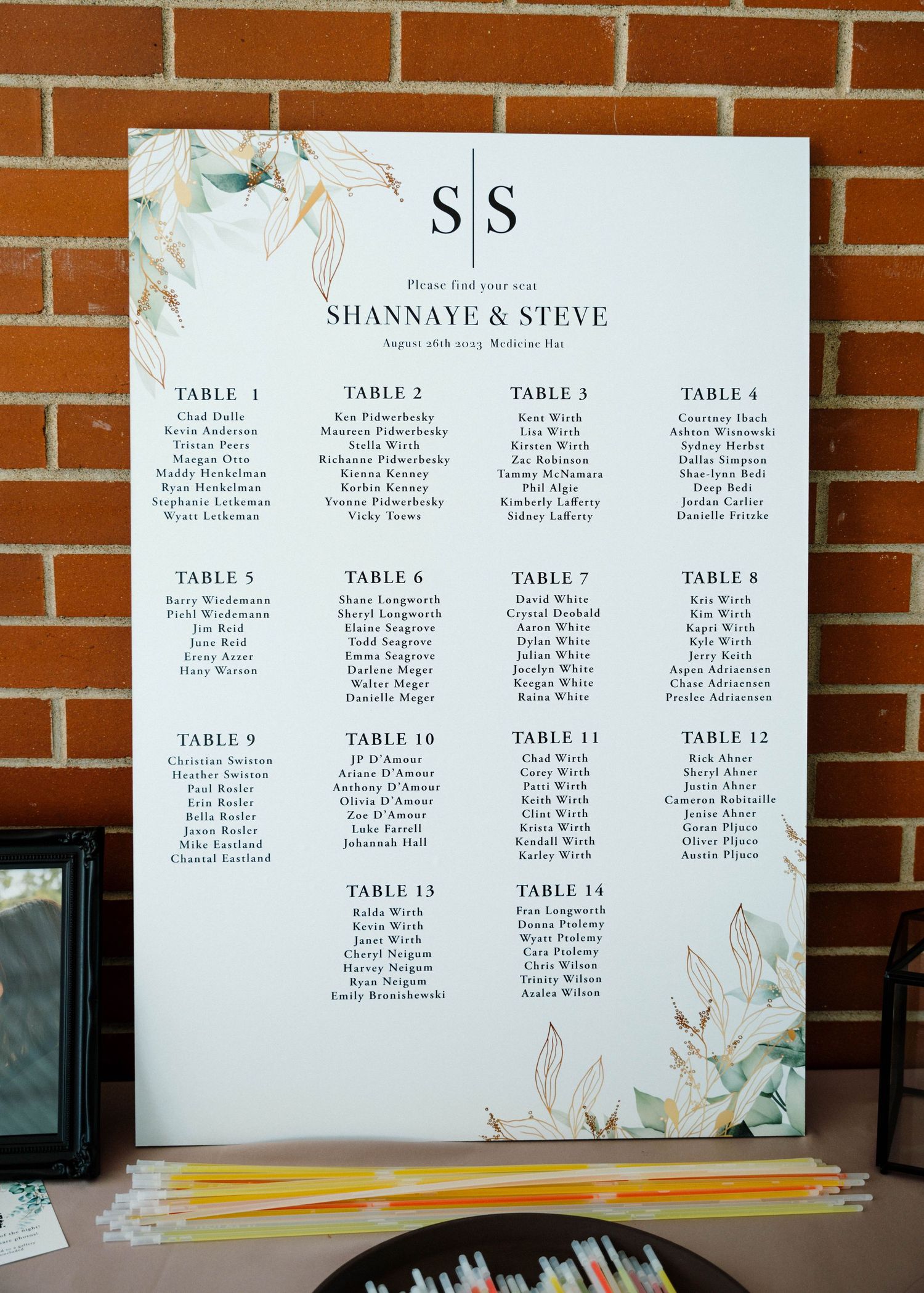 Wedding seating chart for Shannaye and Steve with botanical design showing 14 guest tables.