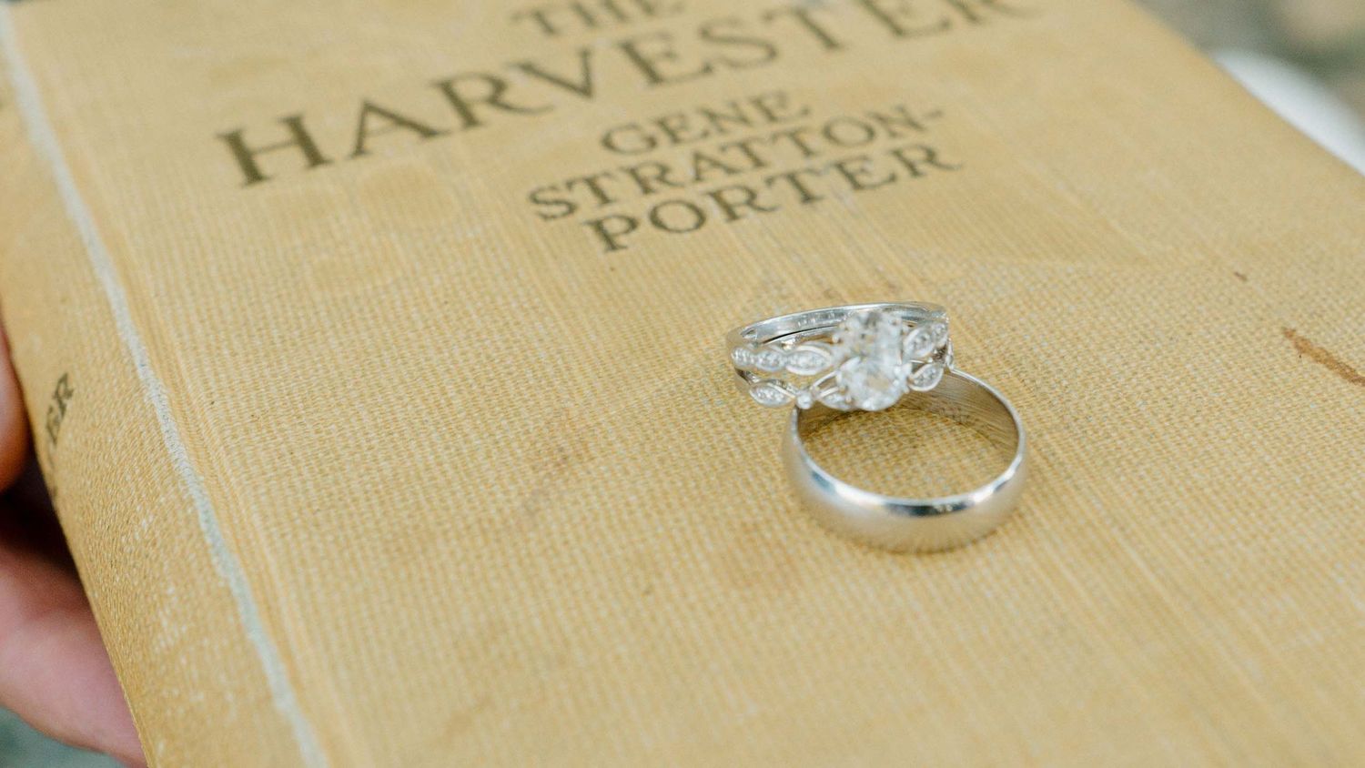 Silver diamond ring resting on a vintage copy of The Harvester by Gene Stratton-Porter.