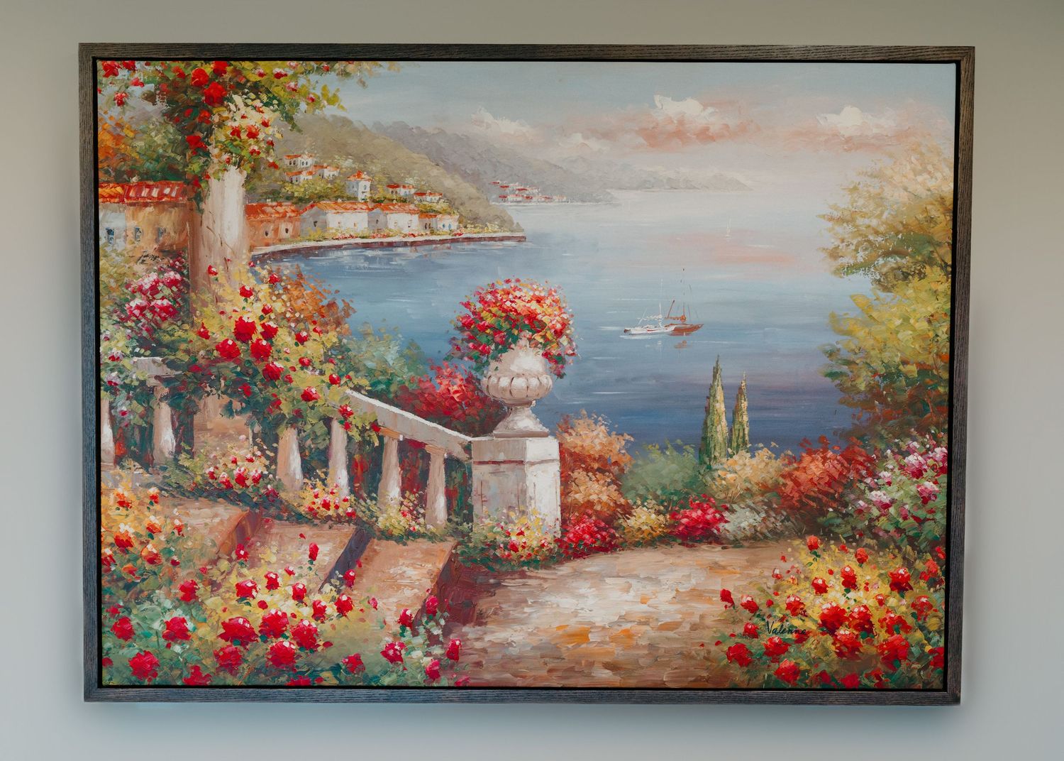 Framed oil painting of a Mediterranean coastal terrace with colorful red flowers, stone balustrade, and serene blue sea view.