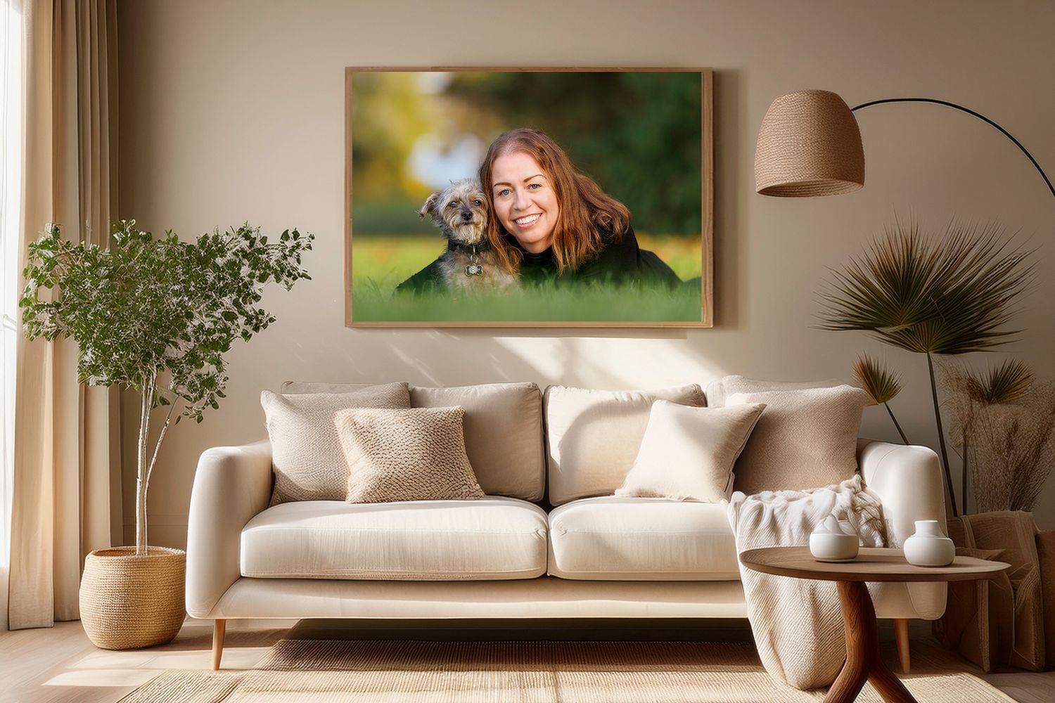 A smiling woman with her Yorkshire Terrier dog displayed as a framed photo print above a modern beige living room sofa.