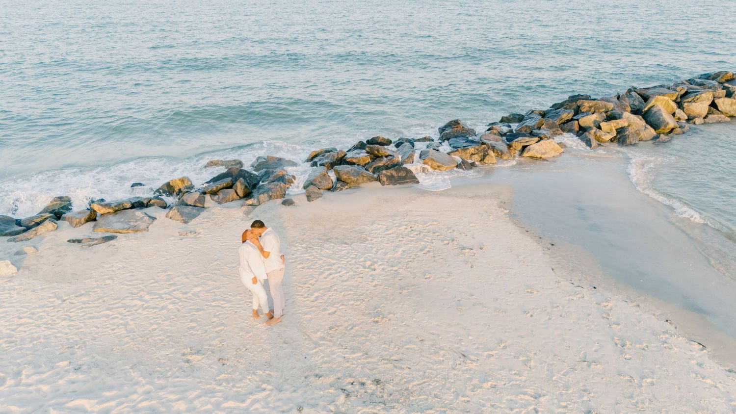 Couples portrait on the beach in Hampton, Virginia at Buckroe Beach.