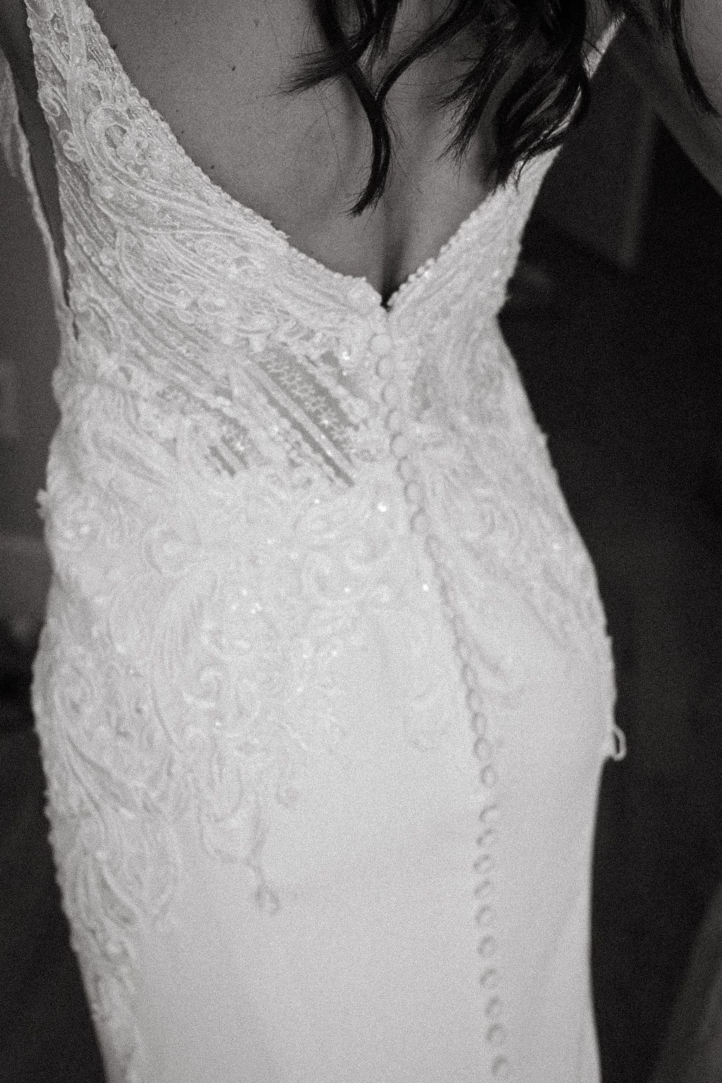 Softly lit portrait of a bride by a window, highlighting the grace and anticipation of the morning as she gets ready.