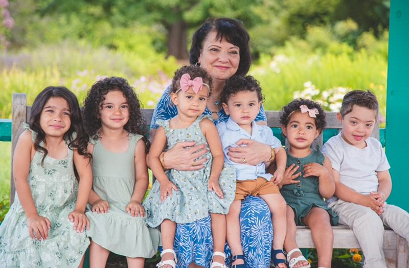 Soft, intimate portrait of a grandmother and grandchildren, highlighting the tender connection and grace of family life.