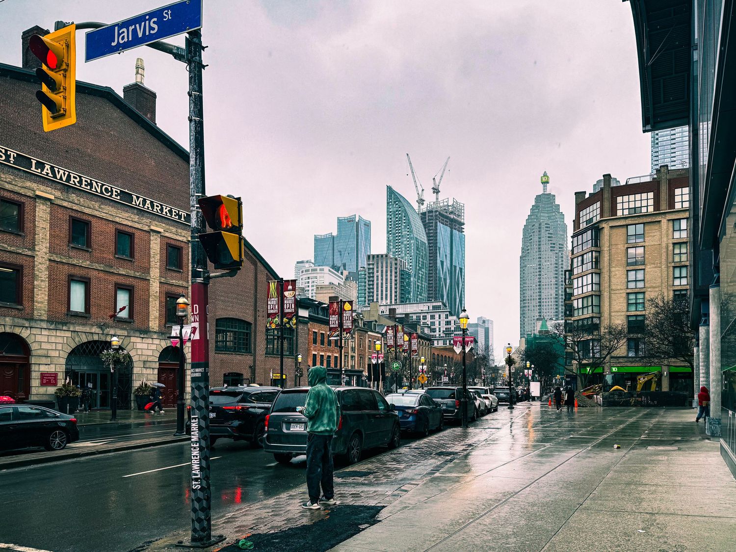 Rainy day on Jarvis Street in Toronto with St. Lawrence Market and city skyline visible.