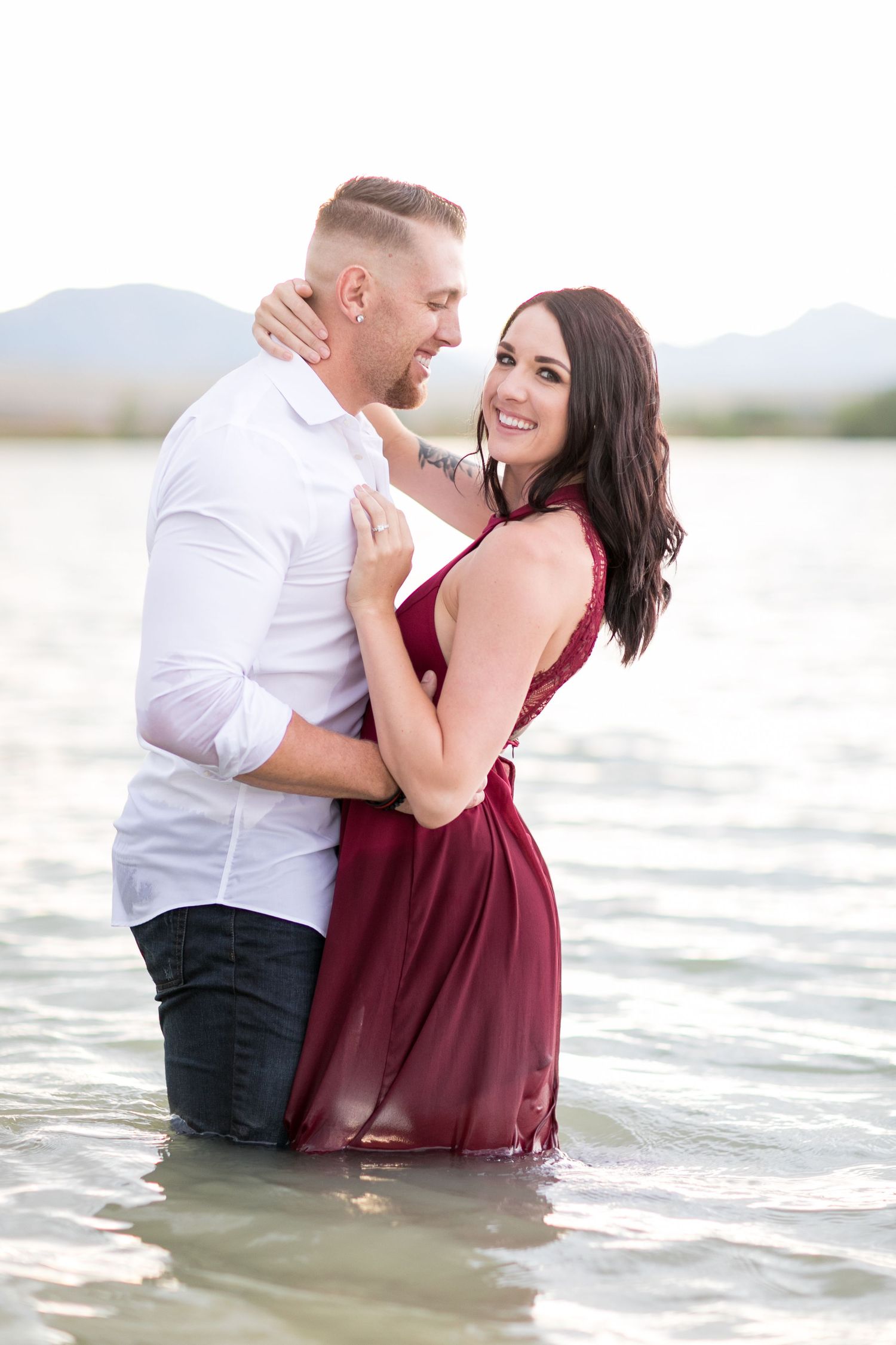 couple embracing in lake during anniversary photo session Boulder Colorado
