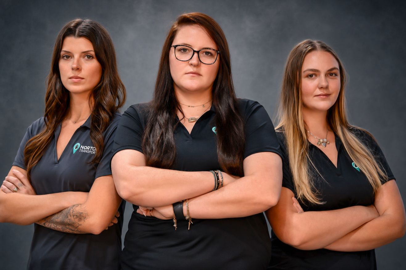 Three professional women in black uniforms stand with arms crossed against a gray background.
