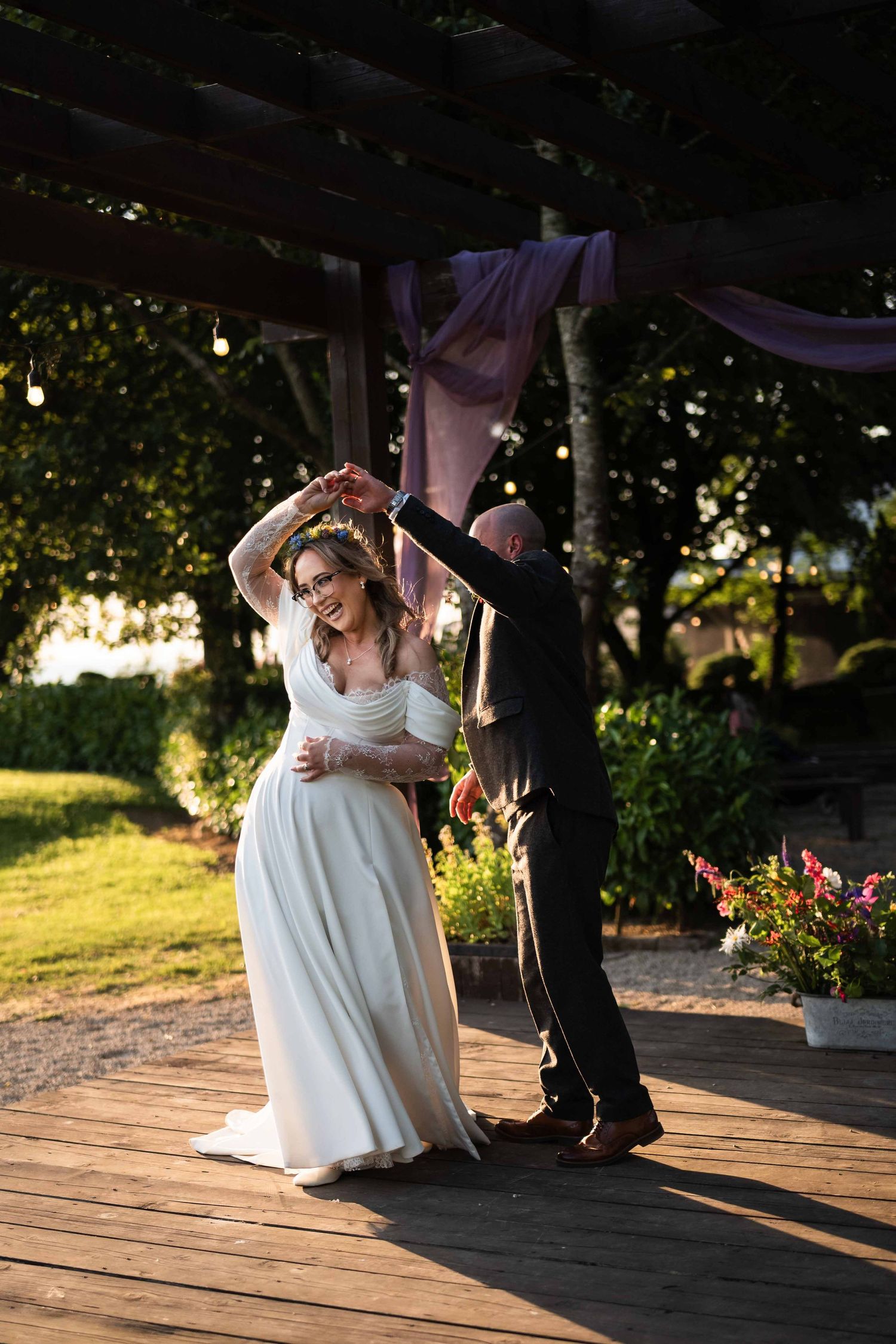 Bride and groom sharing a first dance on an outdoor wooden deck at sunset. Irish wedding photography. Mountain View, Kilkenny