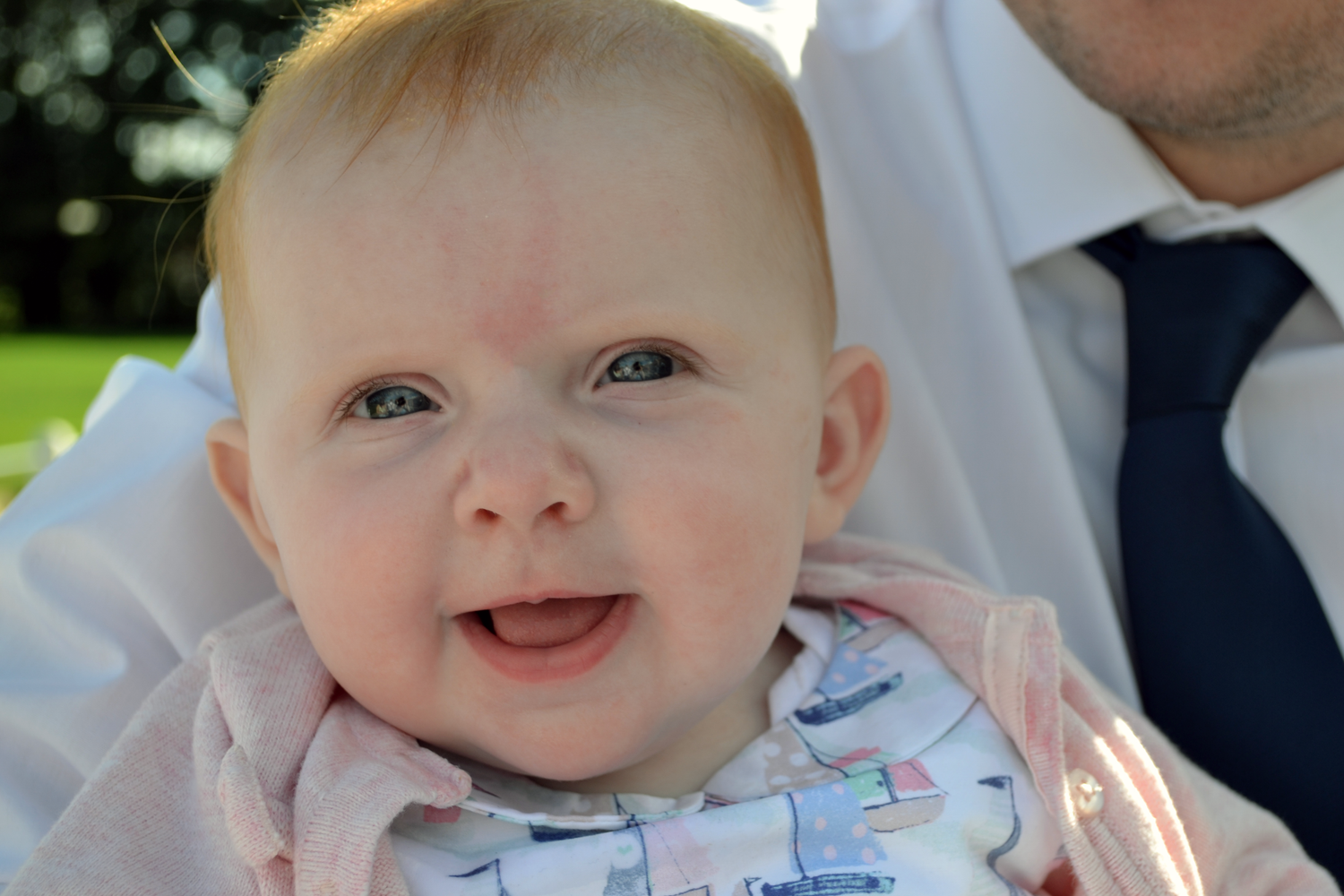 portrait shot of a baby enjoying herself at a wedding.