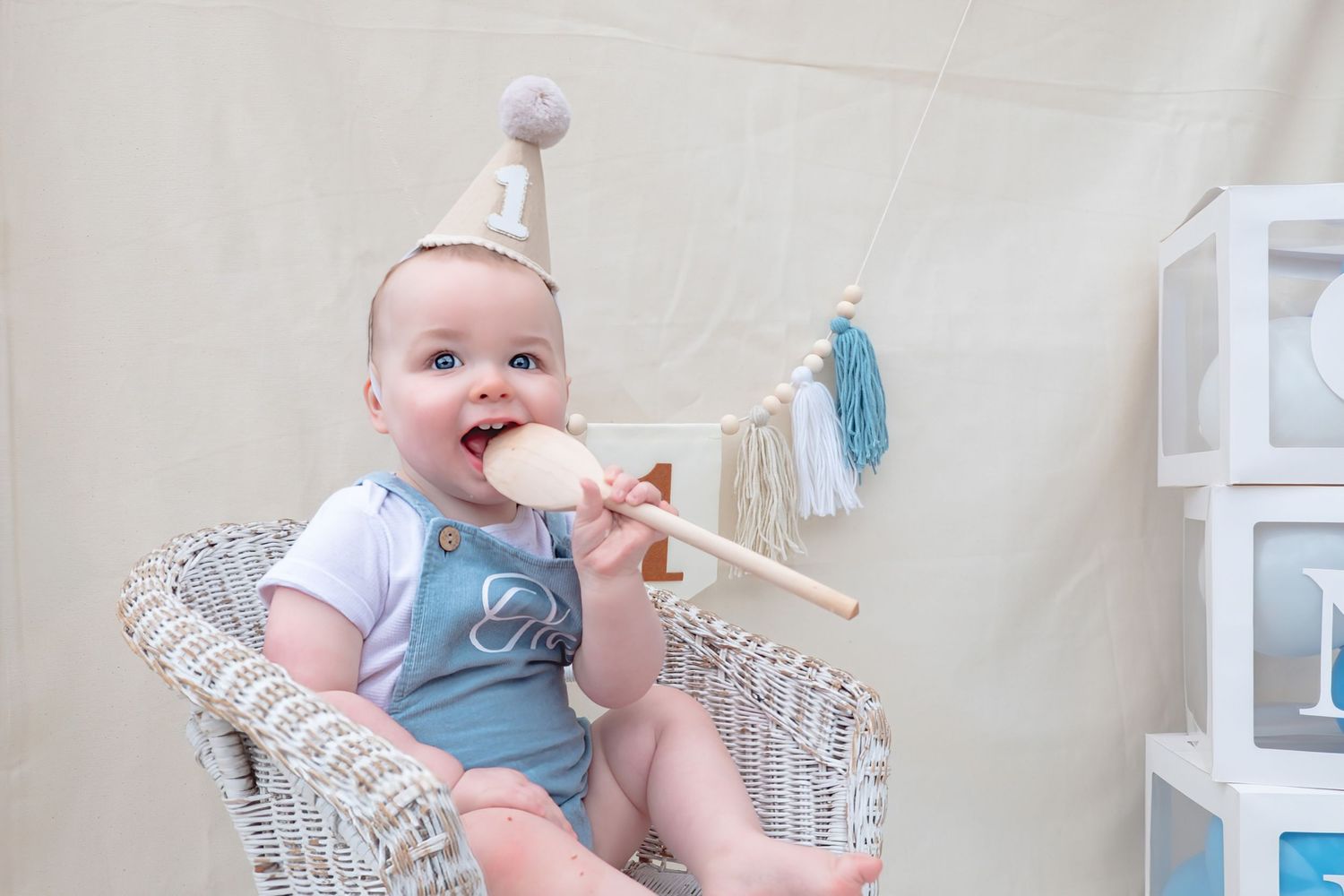 Little boy enjoying his first birthday cake smash photoshoot.