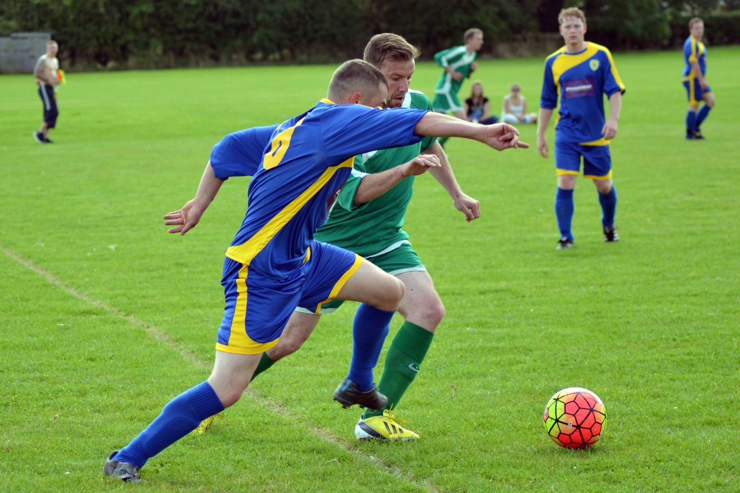 Two men playing football about to tackle each other