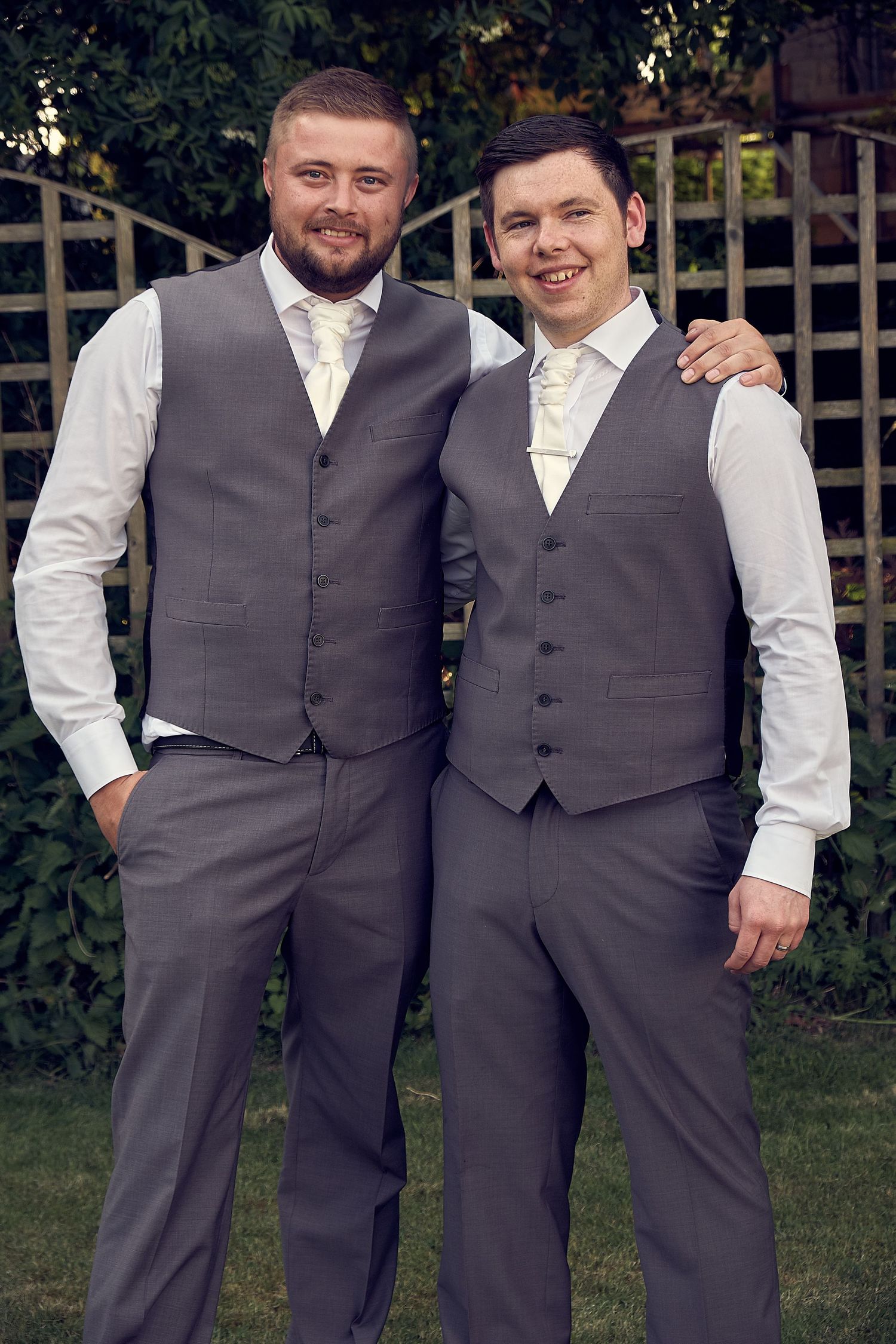 Groom and Best Man posing for a photo,.
