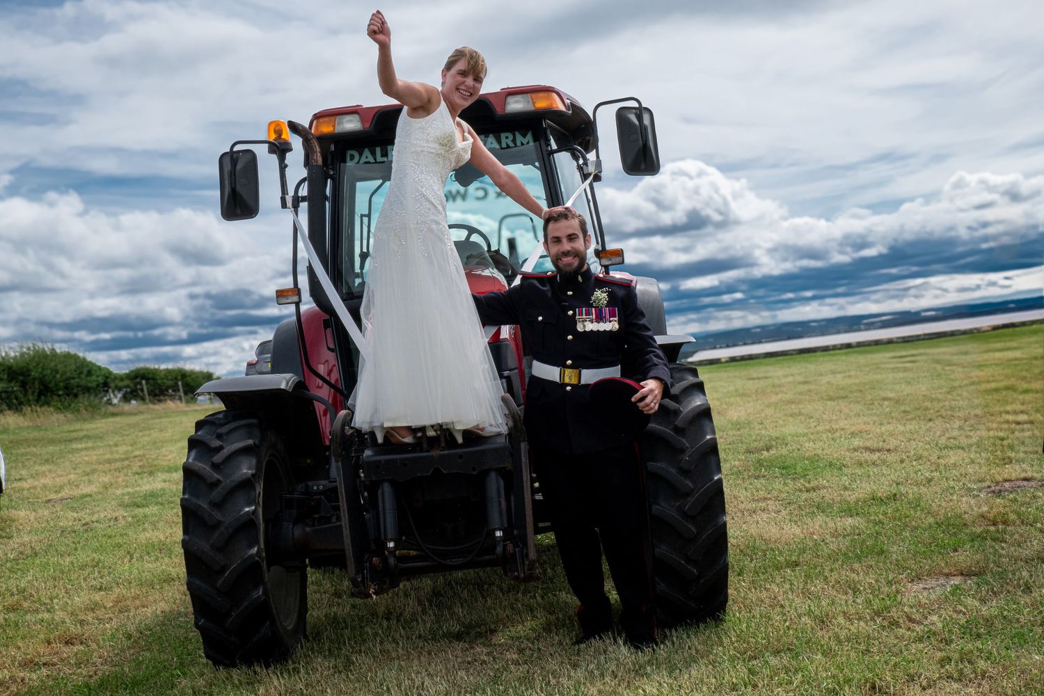 Bride and groom sharing a funny portrait after their wedding ceremony on the tractor.