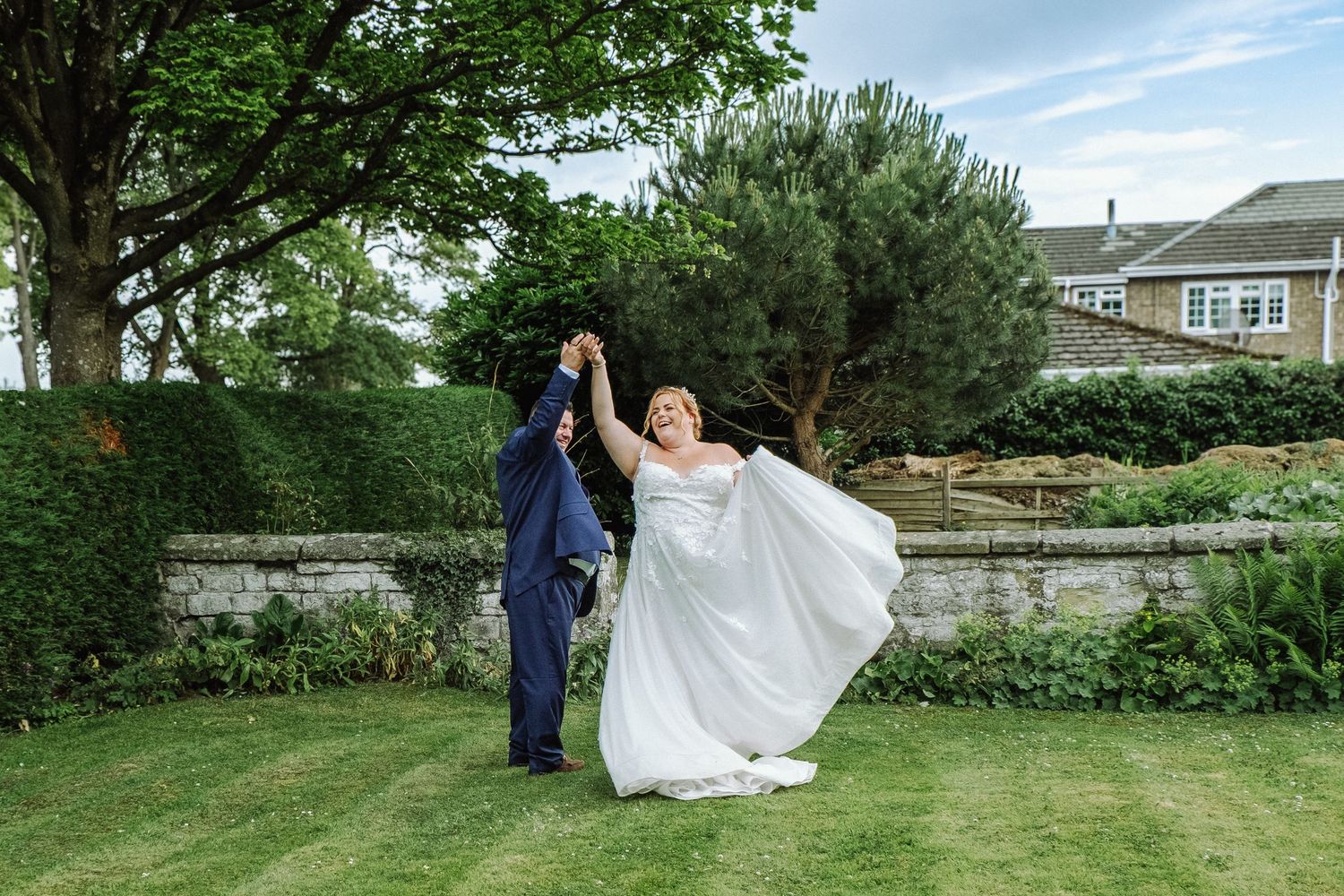 Bride and Groom dancing in the gardens of the wedding venue.