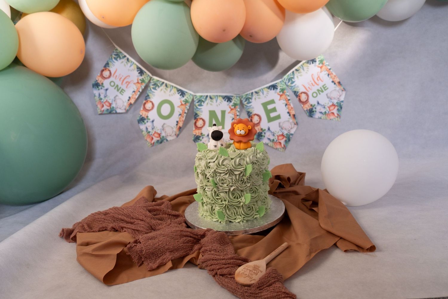 An animal first birthday cake ready for a cake smash photoshoot.