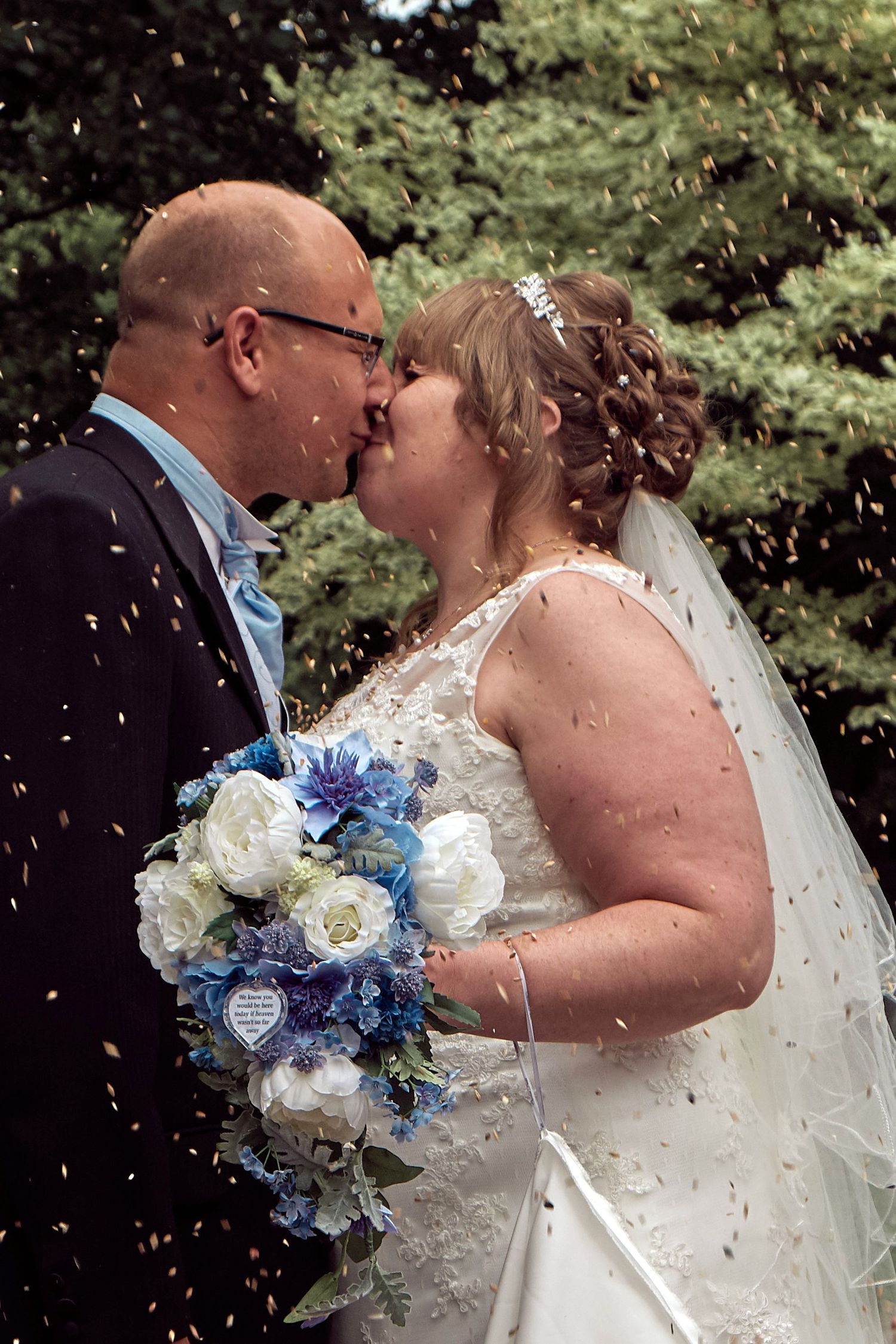 Bride and groom sharing a confetti walk outside the church after their wedding ceremony.