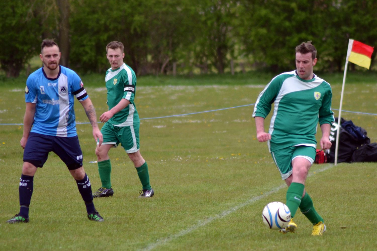 Two football players competing for possession during a competitive football match.