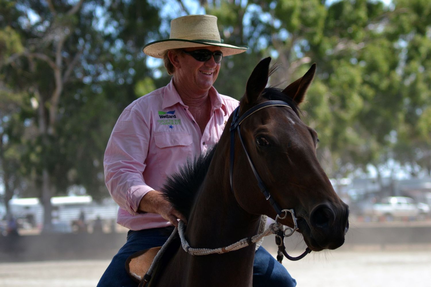 Man on a horse parading around a ring.