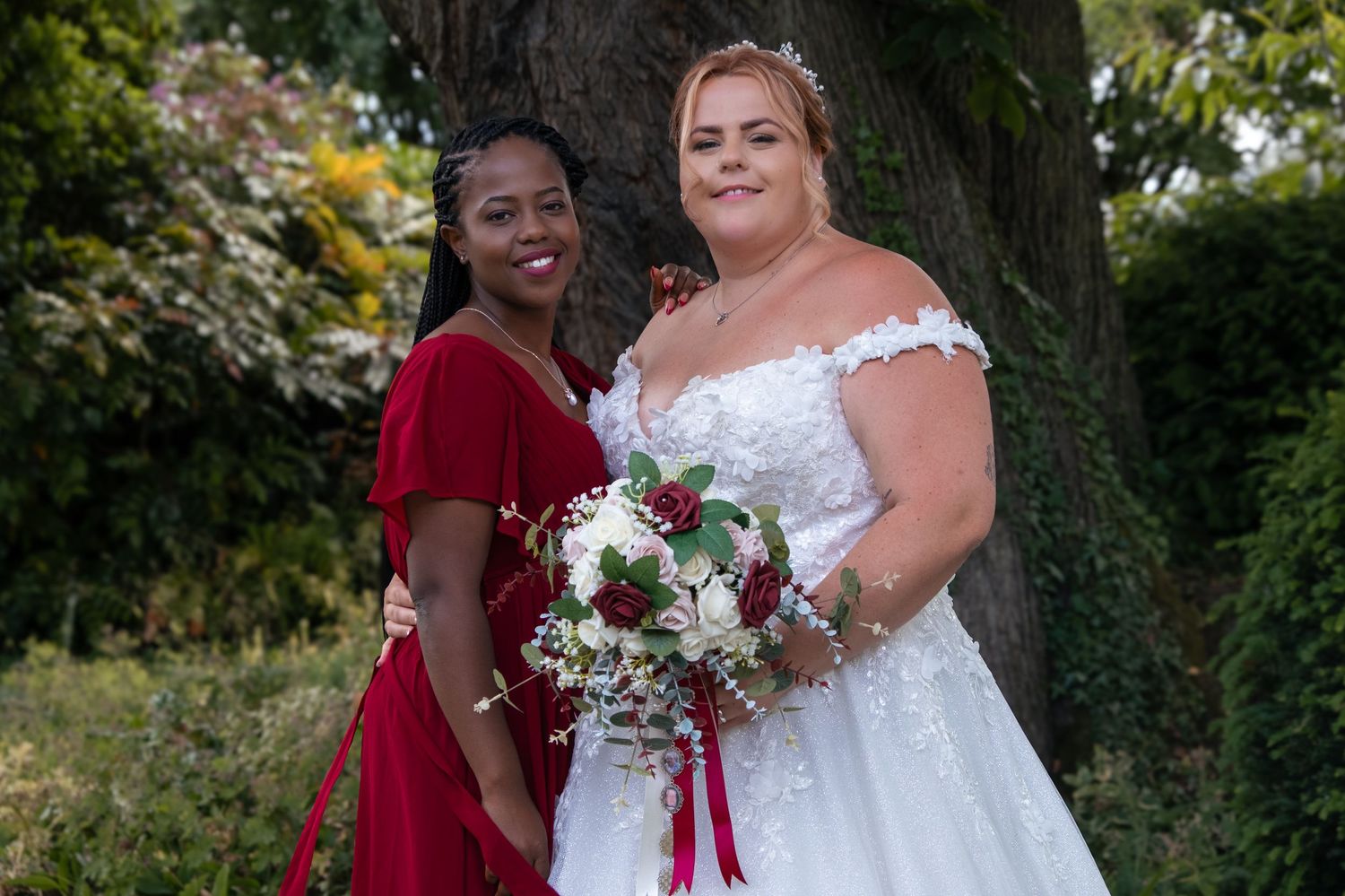 Bride with Maid of Honour in the wedding venue gardens.