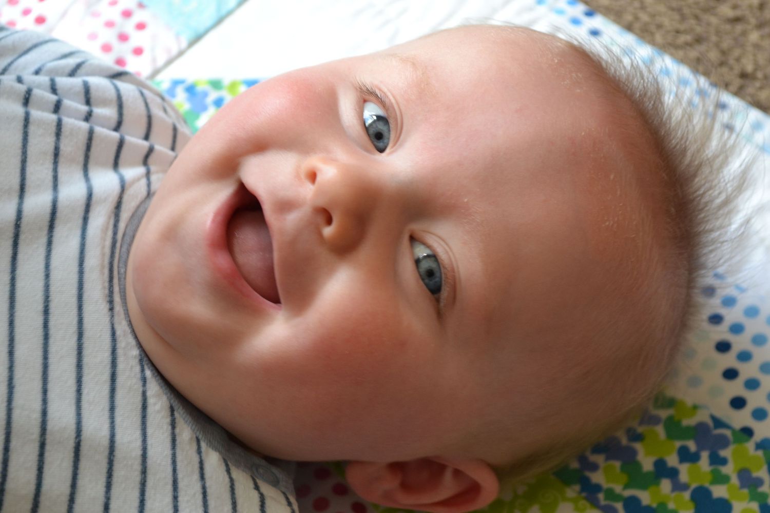portrait shot of a baby laughing.