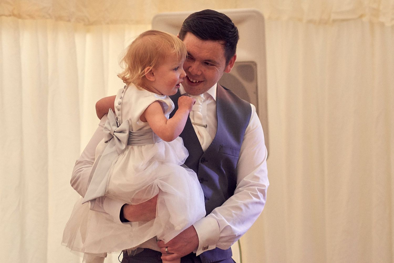 Groom with his daughter at the wedding reception.