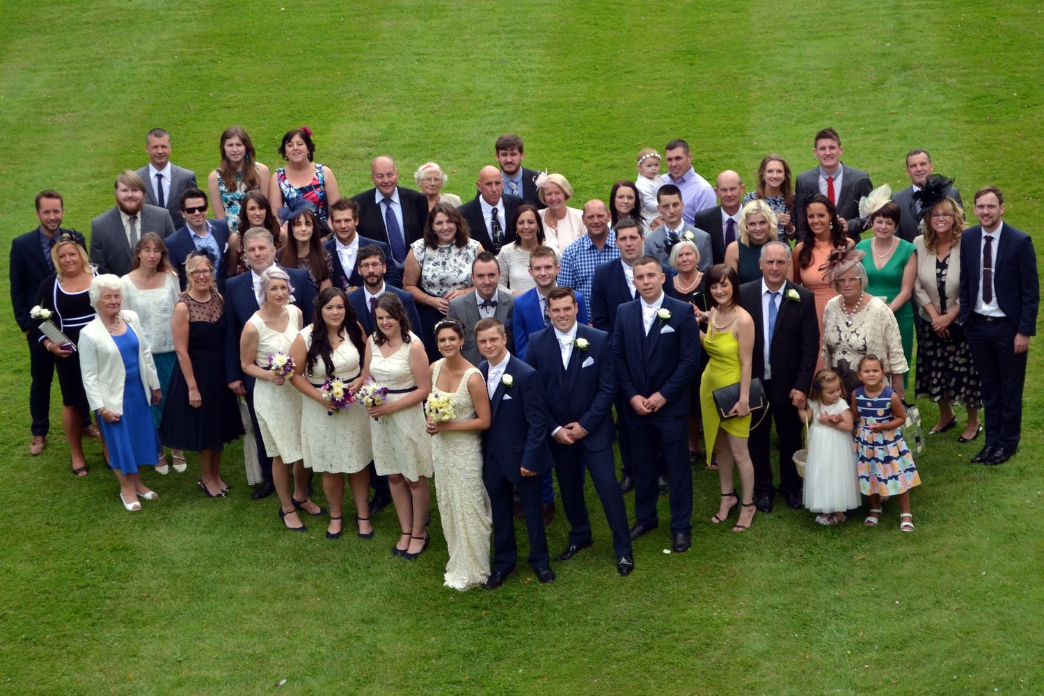 Group shot of all the wedding guests outside the wedding venue.