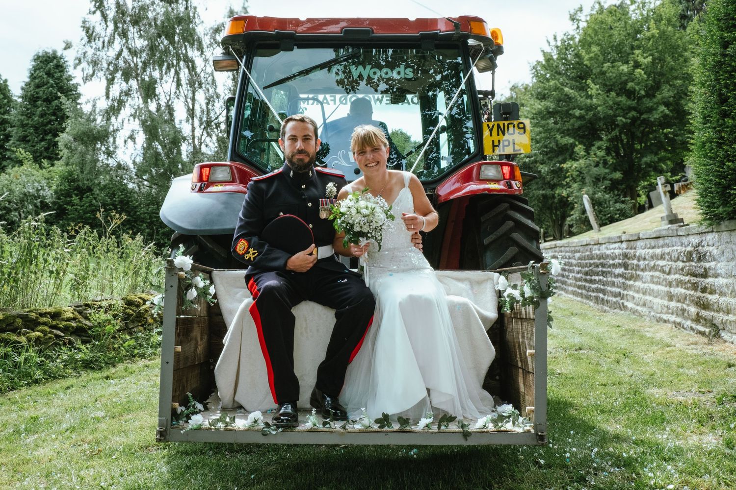 photograph of the Bride and Groom on the tractor driving away from the church to the recption venue.