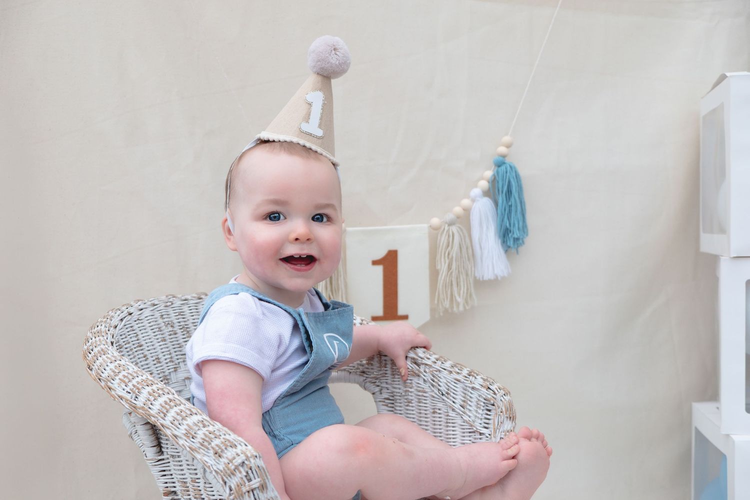 Little boy enjoying his first birthday cake smash photoshoot.