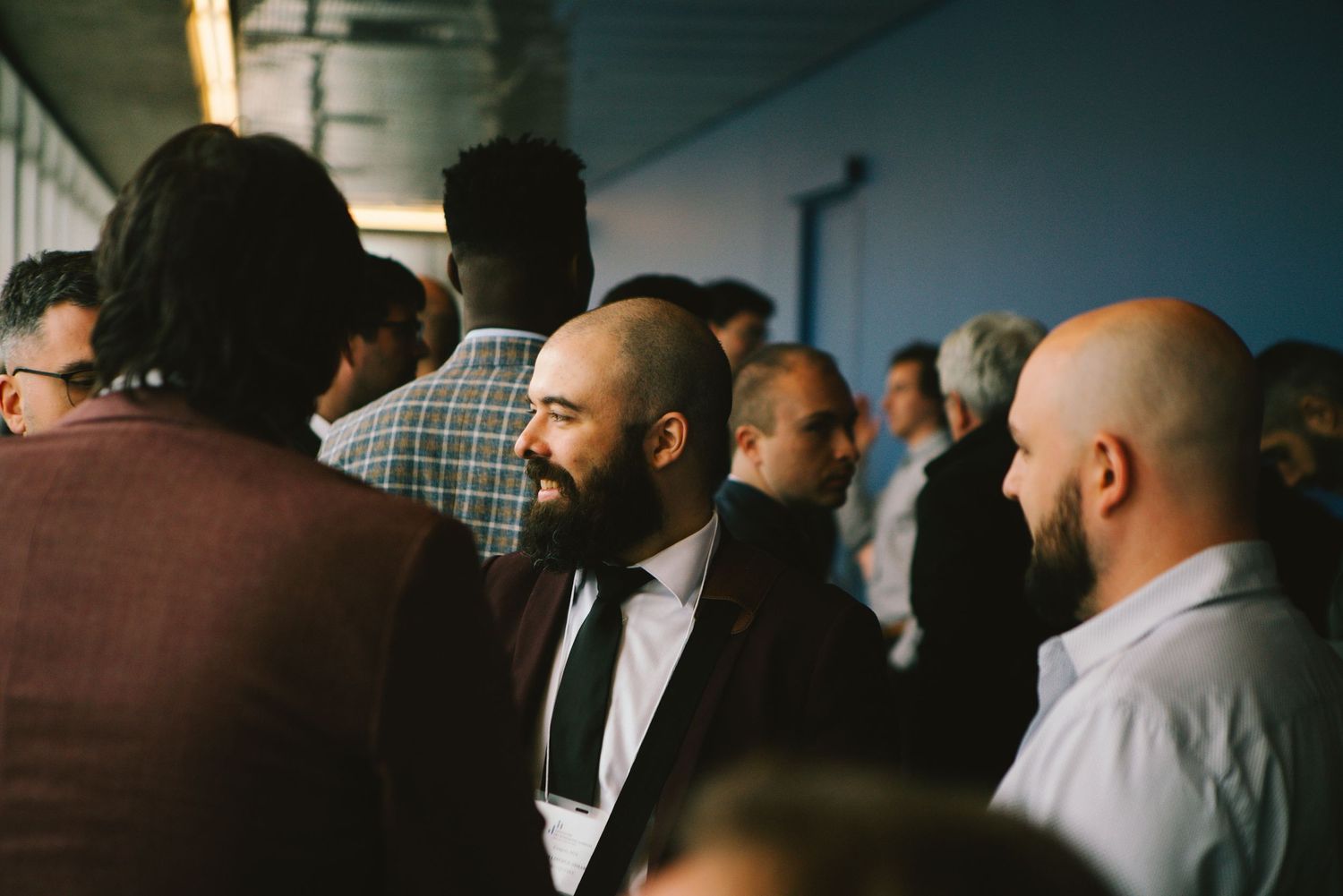 Crowd of professionals networking at a corporate event, photography by HAMIDI Photography.